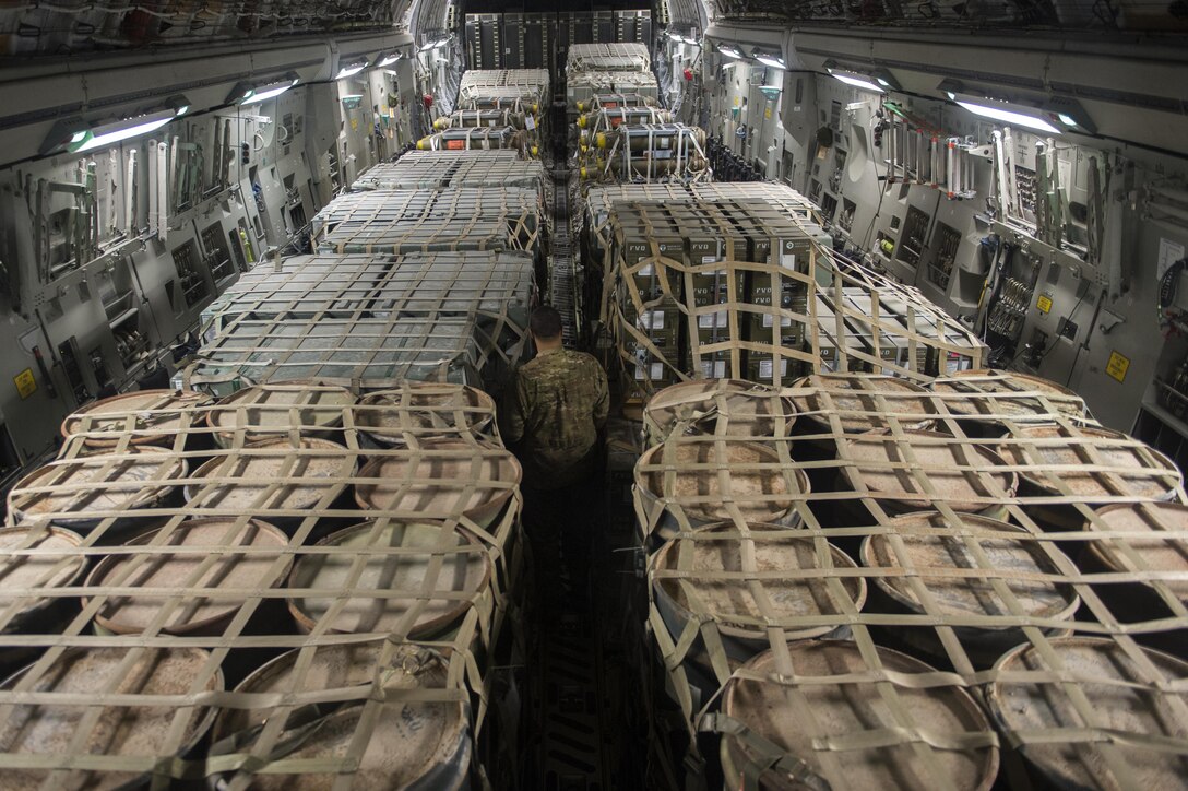 U.S. Air Force Staff Sgt. Curtis Sibby prepares cargo for travel at Al Udeid Air Base, Qatar, in support of Operation Inherent Resolve, Dec. 22, 2015. Sibby is a loadmaster assigned to the 816th Expeditionary Airlift Squadron loadmaster. U.S. Air Force photo by Tech. Sgt. Nathan Lipscomb