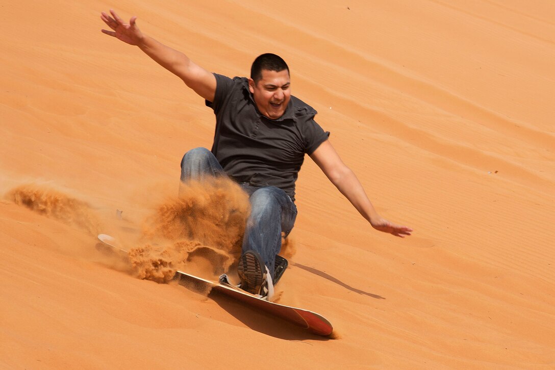 U.S. Navy Petty Officer 1st Class Steve Barbosa sandboards during a port visit to Jebel Ali, United Arab Emirates, Dec. 25, 2015. Barbosa is assigned to the USS Kearsarge, which is deployed in support of security efforts in the U.S. 5th Fleet area of responsibility. U.S. Navy photo by Petty Officer Seaman Dana D. Legg