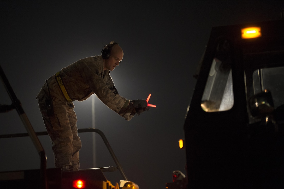 U.S. Air Force Staff Sgt. Andrew Shanahorn marshals a 60K loader at Incirlik Air Base, Turkey, in support of Operation Inherent Resolve, Dec. 22, 2015. Shanahorn is assigned to the 728th Air Mobility Squadron.