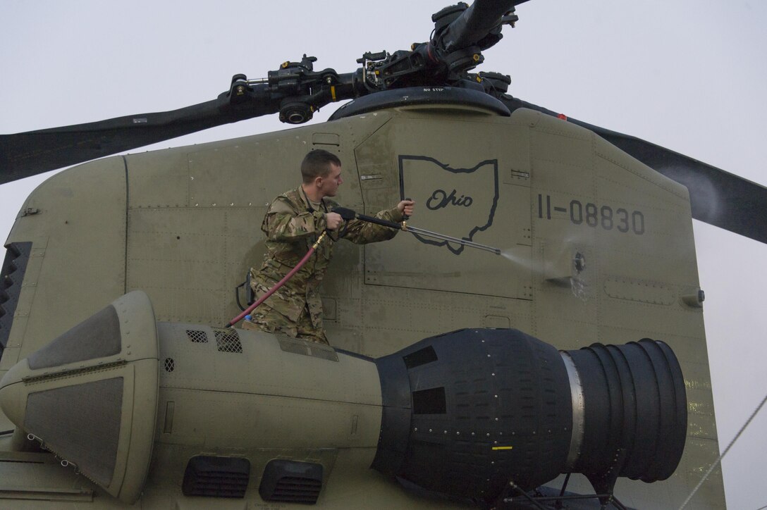 U.S. Army Spc. David Casement washes a CH-47 Chinook helicopter at Bagram Airfield, Afghanistan, Dec. 29, 2015. Casement is assigned to the Michigan National Guard's 3rd Battalion, 238th Aviation Regiment, General Support Aviation Brigade. U.S. Army photo by Sgt. 1st Class Nathan Hutchison    