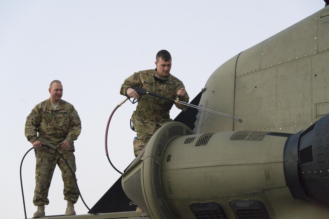 U.S. Army Spc. David Casement, right, and Staff Sgt. Kenneth Andersen wash a CH-47 Chinook helicopter at Bagram Airfield, Afghanistan, Dec. 29, 2015. Casement is assigned to the Michigan National Guard's 3rd Battalion, 238th Aviation Regiment, General Support Aviation Brigade. U.S. Army photo by Sgt. 1st Class Nathan Hutchison