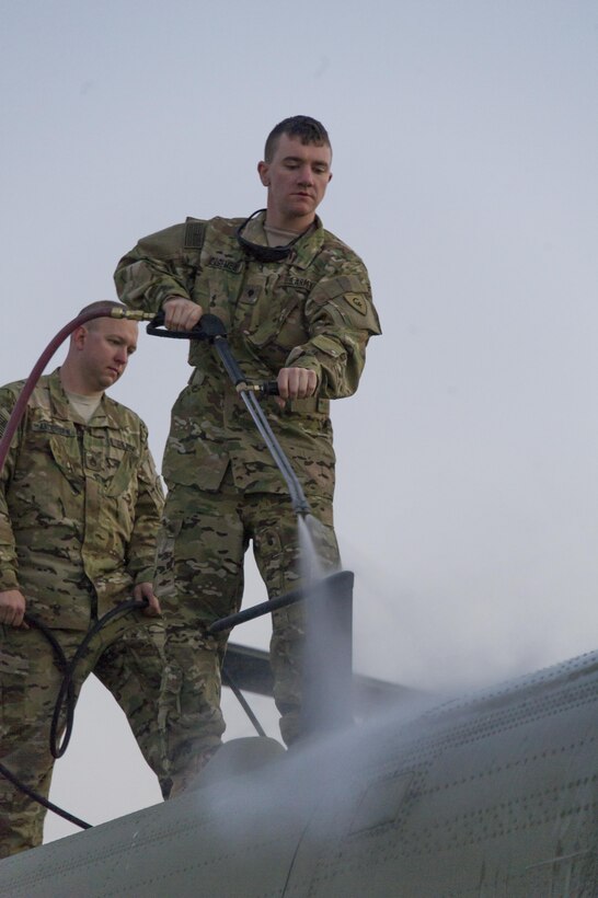 U.S. Army Spc. David Casement, right, and Staff Sgt. Kenneth Andersen wash a CH-47 Chinook helicopter at Bagram Airfield, Afghanistan, Dec. 29, 2015. Casement is assigned to the Michigan National Guard's 3rd Battalion, 238th Aviation Regiment, General Support Aviation Brigade. U.S. Army photo by Sgt. 1st Class Nathan Hutchison  