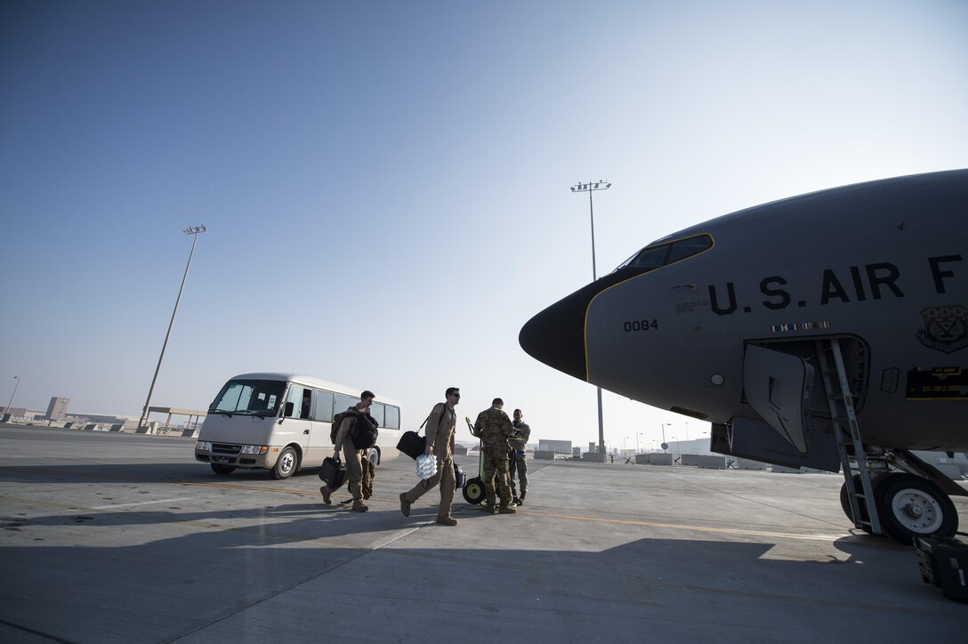 U.S. Air Force airmen walk to a KC-135 Stratotanker before a refueling mission at Al Udeid Air Base, Qatar, Dec. 29, 2015. The aircrew is assigned to the 340th Expeditionary Air Refueling Squadron. 