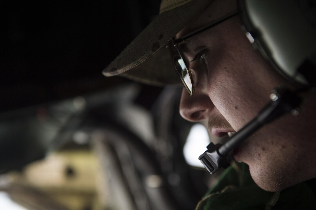 U.S Air Force Airman 1st Class Garrett Peirce talks with the pilots while flying on a KC-135 Stratotanker over Afghanistan, Dec. 29, 2015. Peirce is a boom operator assigned to the 340th Expeditionary Air Refueling Squadron, deployed from the 92nd Air Refueling Wing at Fairchild Air Force Base, Wash. U.S. Air Force photo by Staff Sgt. Corey Hook  