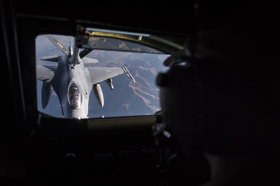U.S Air Force Airman 1st Class Garrett Peirce refuels a U.S. Air Force F-16 Fighting Falcon over Afghanistan, Dec. 29, 2015. Peirce is a boom operator assigned to the 340th Expeditionary Air Refueling Squadron, deployed from the 92nd Air Refueling Wing at Fairchild Air Force Base, Wash. U.S. Air Force photo by Staff Sgt. Corey Hook
