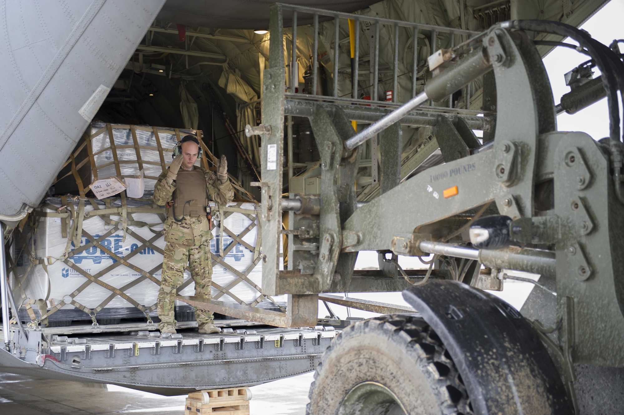 Staff Sgt. Justin King, a 774th Expeditionary Airlift Squadron loadmaster, guides a forklift toward the aft loading ramp of a C-130J Super Hercules at Camp Bastion, Afghanistan, Jan. 3, 2016. Loadmasters are responsible for calculating aircraft weight, balancing records and cargo manifests, conducting cargo and personnel airdrops, and troubleshooting in-flight problems. King is deployed from Dyess Air Force Base, Texas. (U.S. Air Force photo/Tech. Sgt. Robert Cloys)
