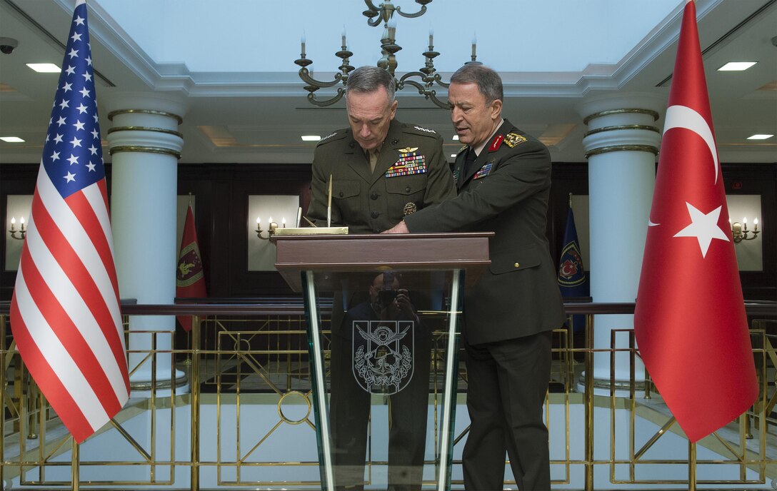 U.S. Marine Corps Gen. Joseph F. Dunford Jr., chairman of the Joint Chiefs of Staff, signs a guest book before an office call with Turkish Gen. Hulusi Akar, right, chief of the general staff of the Turkish Armed Forces, in Ankara, Turkey, Jan. 6, 2016. DoD photo by Navy Petty Officer 2nd Class Dominique A. Pineiro