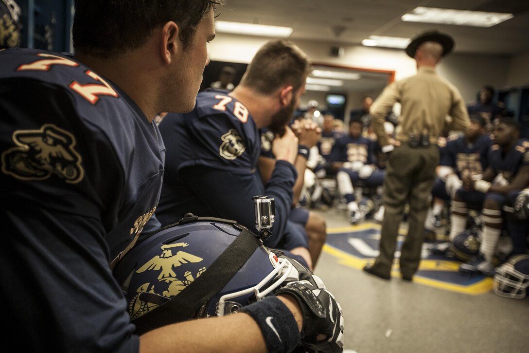 Members of the East Team listen as a Drill Instructor gives a motivational speech prior to the start of the Semper Fidelis All-American Bowl at the StubHub Center in Carson, CA, Jan. 3, 2016. The annual bowl game is made up of high school seniors hand selected from around the country to make up west and east coast teams. (U.S. Marine Corps photo by Sgt. Melissa Marnell, Office of the Sergeant Major of the Marine Corps/Released)