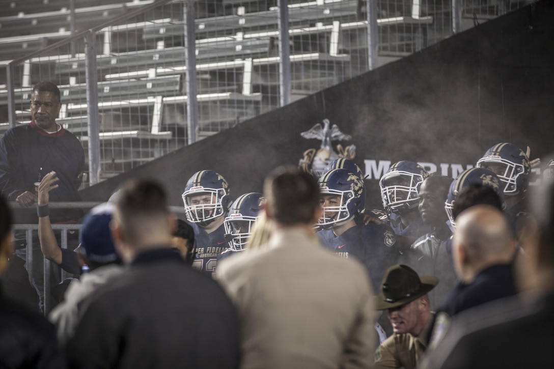 Players for the East Team enter the field prior to the start of the Semper Fidelis All-American Bowl at the StubHub Center in Carson, CA, Jan. 3, 2016. The annual bowl game is made up of high school seniors hand selected from around the country to make up west and east coast teams. (U.S. Marine Corps photo by Sgt. Melissa Marnell, Office of the Sergeant Major of the Marine Corps/Released)