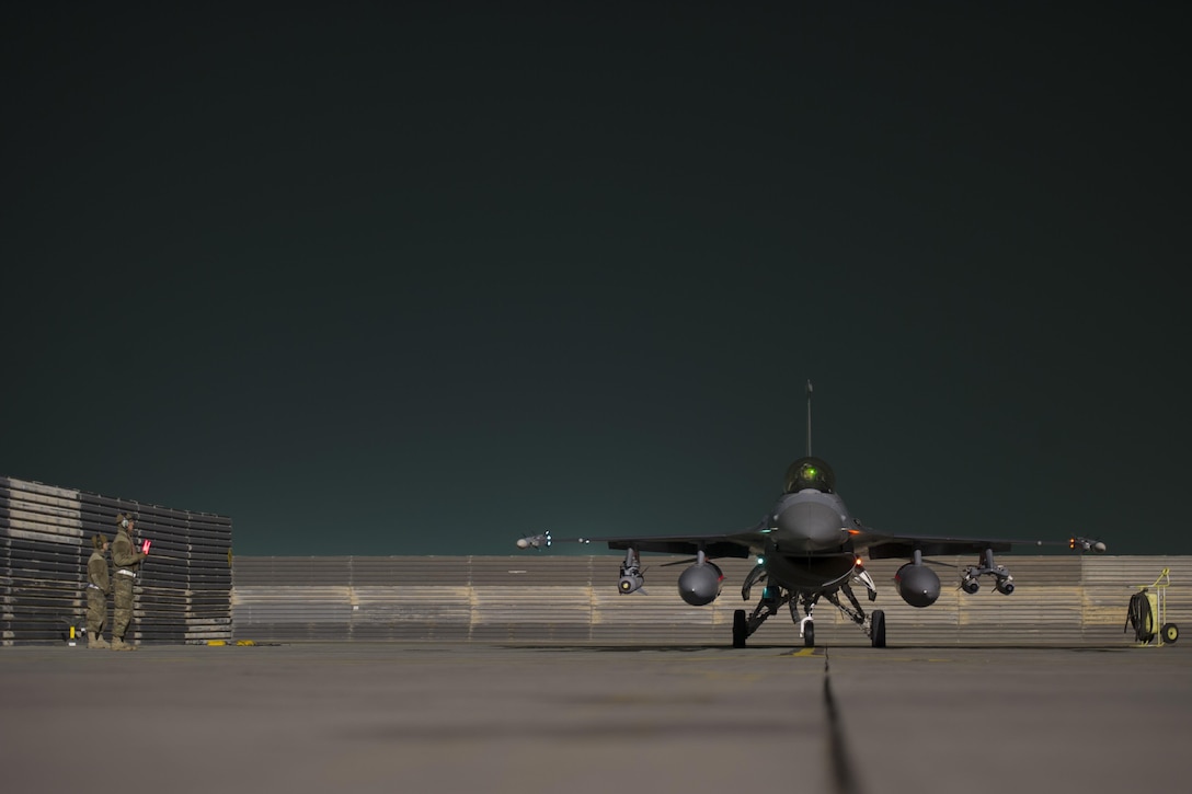 U.S. airmen signal the pilot in an F-16 Fighting Falcon aircraft after finishing final checks before departing on a sortie in support of ground operations in Helmand province, Afghanistan, Jan. 6, 2016. U.S. Air Force photo by Tech. Sgt. Robert Cloys