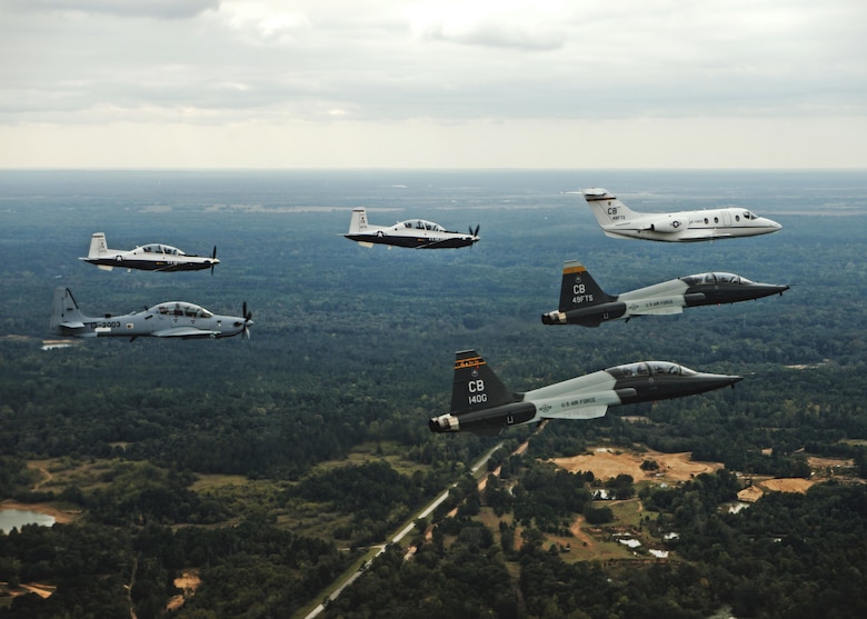 An aircraft from each of the 14th Flying Training Wing flying squadrons were represented in a dissimilar formation in the vicinity of Columbus Air Force Base, Mississippi Oct.1, 2015. The formation was led by the T-1A Jayhawk and flanked by two T-6A Texan II aircraft on its left, two T-38C Talon aircraft on its right and followed by the A-29 Super Tucano behind it. (U.S. Air Force photo/Airman 1st Class Daniel Lile)