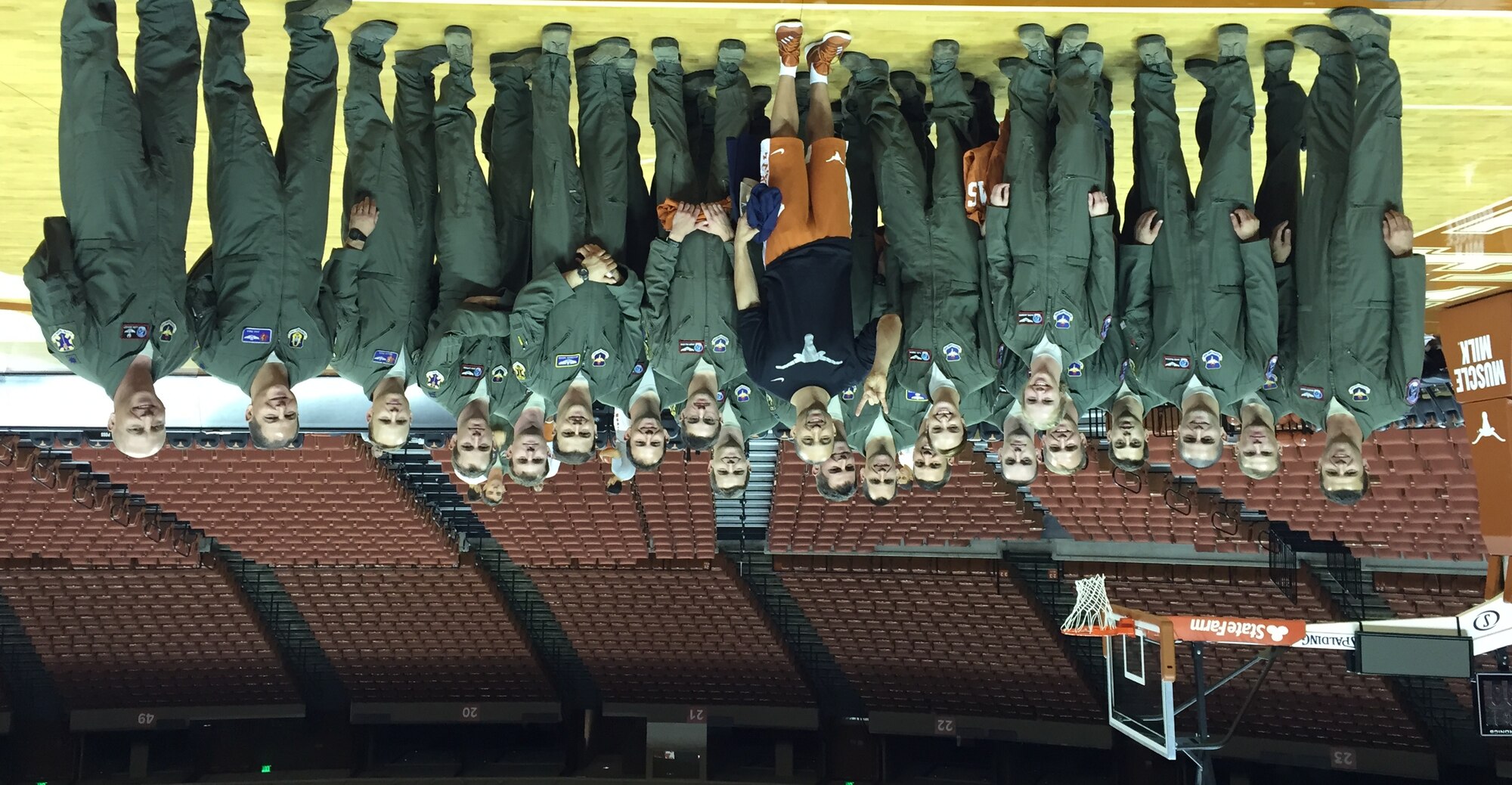 Members of the 435th Fighter Training Squadron pose for a photo with Shaka Smart, head coach of the University of Texas men’s basketball team, 19 Nov. 2015 at the UT basketball stadium. The Deadly Black Eagles met with the coach to discuss leadership and the development of a team. (Courtesy photo) 