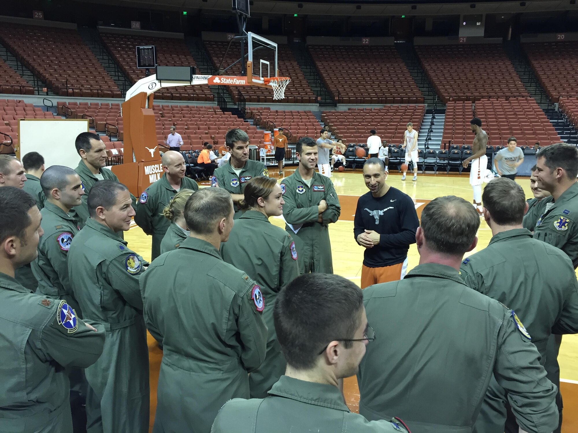 Members of the 435th Fighter Training Squadron engage in a full-court discussion with Shaka Smart, head coach of the University of Texas men’s basketball team, 19 Nov. 2015 at the UT basketball stadium. The Deadly Black Eagles met with the coach to discuss building relationships within a team and leadership philosophies. (Courtesy photo)