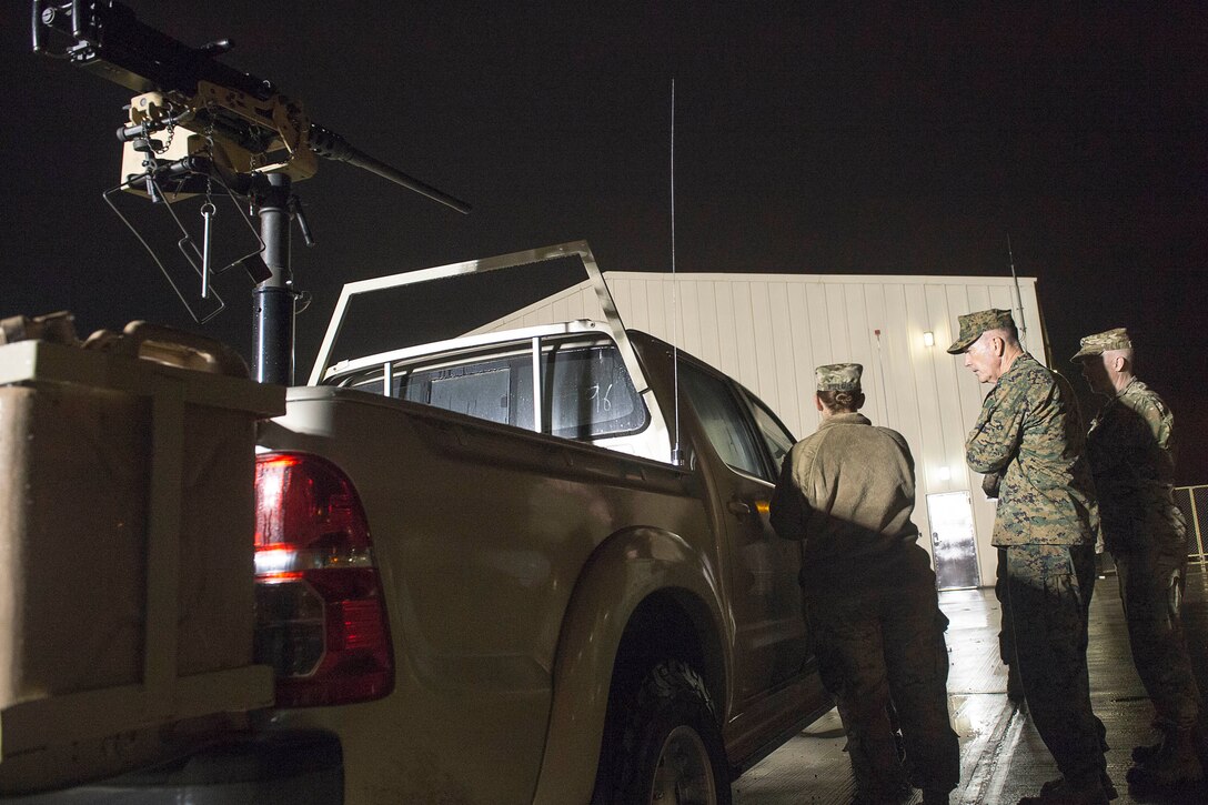 U.S. Army Cpt. Amanda Wielgus, left, assigned to Combined Joint Special Operations Task Force, briefs U.S. Marine Corps Gen. Joseph F. Dunford Jr., right, chairman of the Joint Chiefs of Staff, about trucks modified for combat operations on Incirlik Air Base, Turkey, Jan. 6, 2016. DoD photo by Navy Petty Officer 2nd Class Dominique A. Pineiro