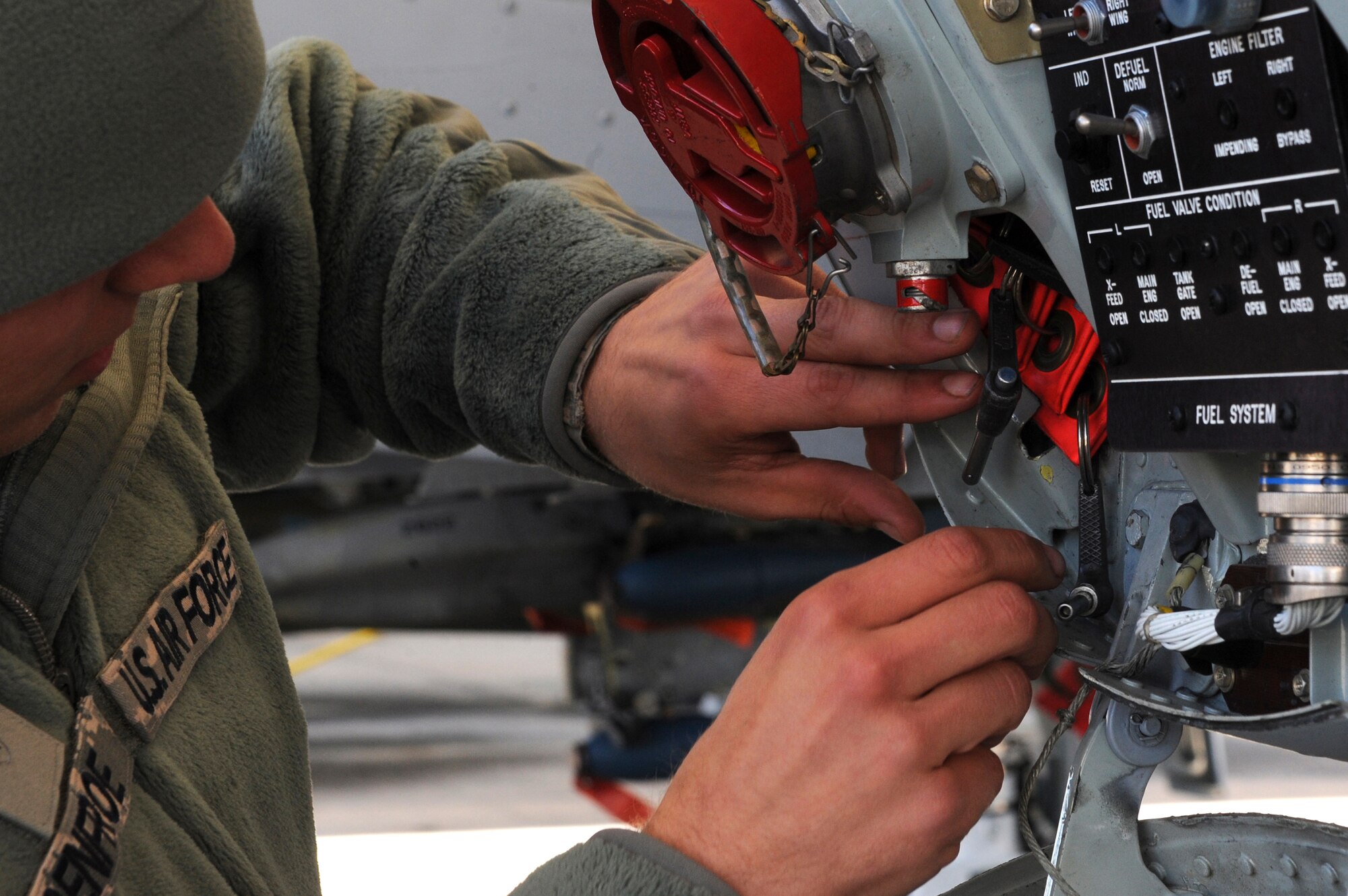 U.S. Air Force Airman 1st Class Chris Renfroe, 74th Aircraft Maintenance Unit crew chief, places landing gear safety pins in an A-10C Thunderbolt II prior to a flight, Jan. 5, 2016, at Moody Air Force Base, Ga. The pins prevent the landing gear from collapsing which could cause a mishap. (U.S. Air Force photo by Airman 1st Class Kathleen D. Bryant/Released)
