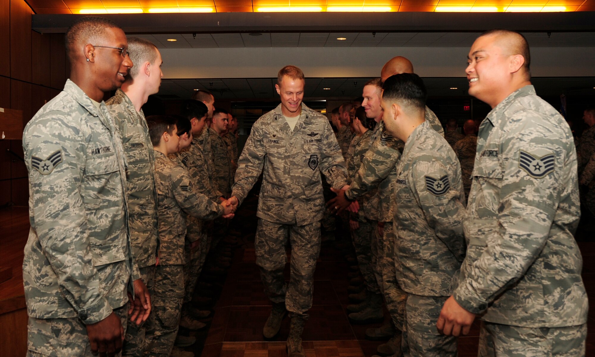 Colonel Derek C. France, 325th Fighter Wing commander, congratulates January promotees Dec. 30, 2015 at the Horizon Community Center after the wing promotion ceremony. These ceremonies are held to acknowledge those receiving a new rank. (U.S. Air Force photo by Senior Airman Solomon Cook/Released)