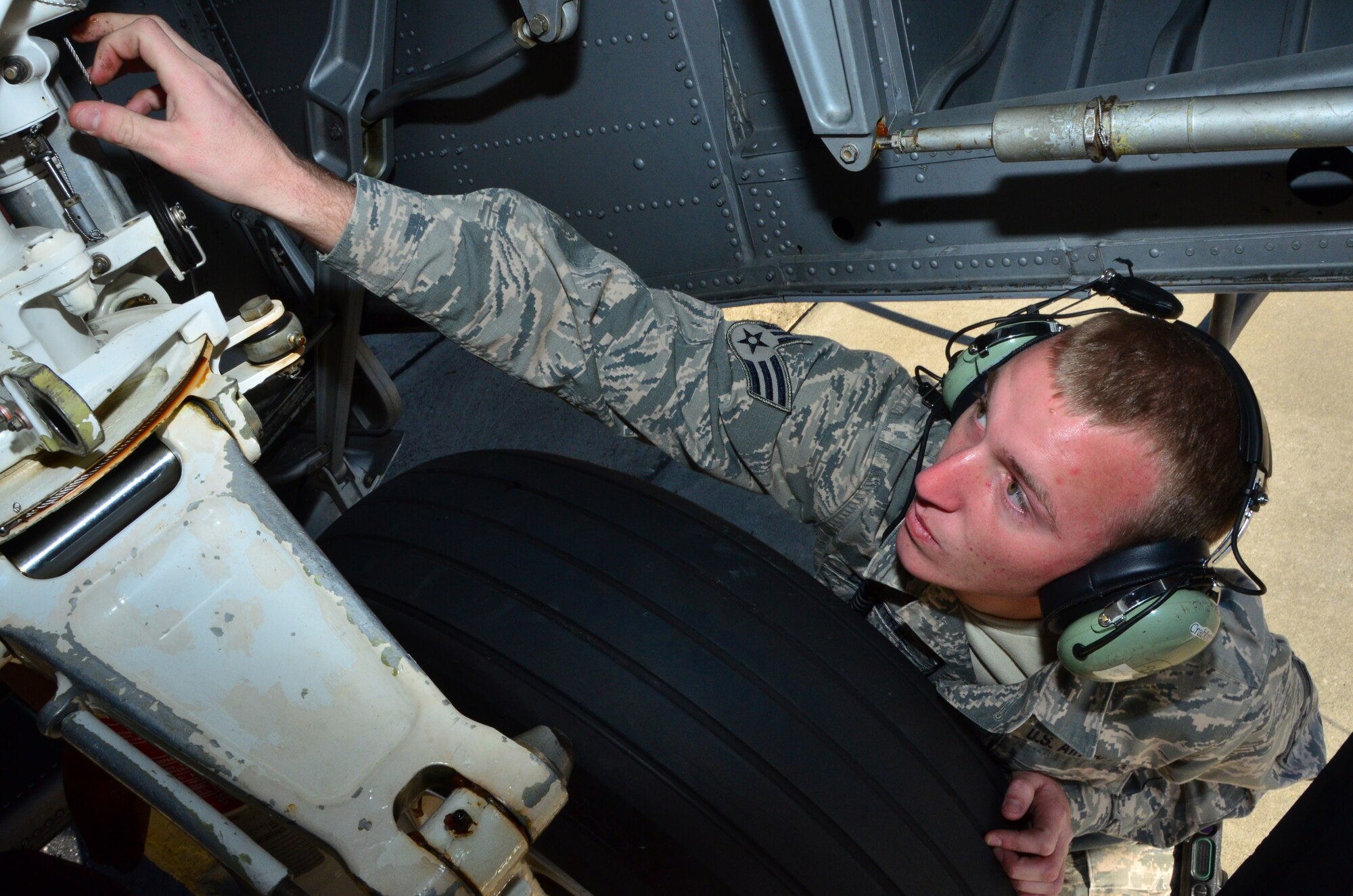 Senior Airman David Crabtree, a crew chief with the 403rd Maintenance Group checks the tires and landing gear for a pre-flight inspection of a routine training flight at Keesler Air Force Base, 6 January, 2015.