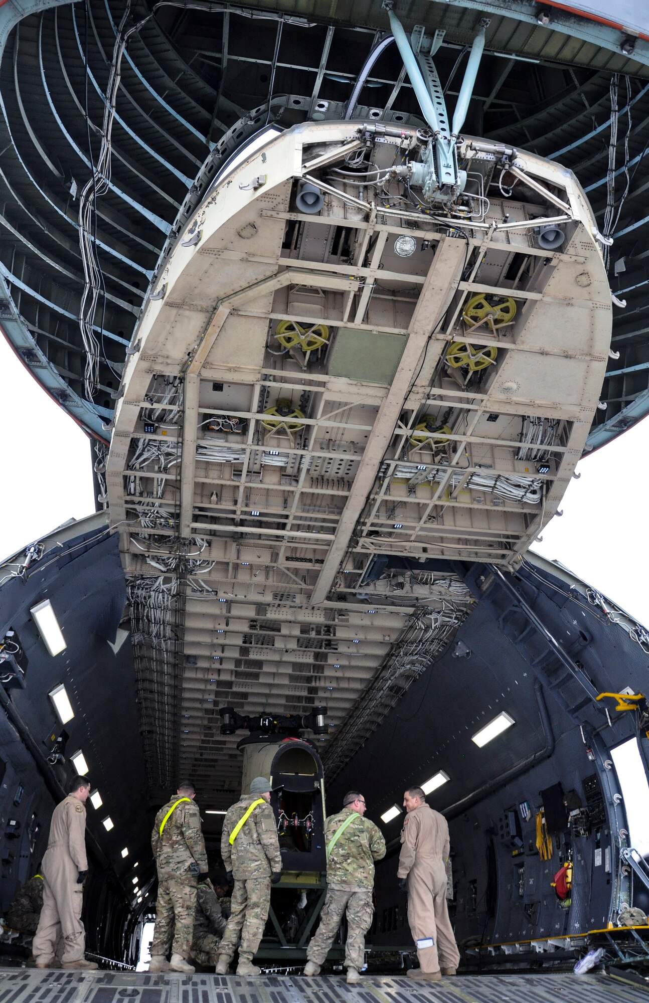 Soldiers from Task Force Destiny pair with Airmen from 9th Airlift Squadron, Dover Air Force Base, Del., to unload a helicopter from a C-5M Super Galaxy at Bagram Air Field, Afghanistan, Dec. 26, 2015. The C-5M is the largest military transport aircraft in the world, capable of hauling 270,000 pounds of cargo. (U.S. Air Force photo by Tech. Sgt. Nicholas Rau)