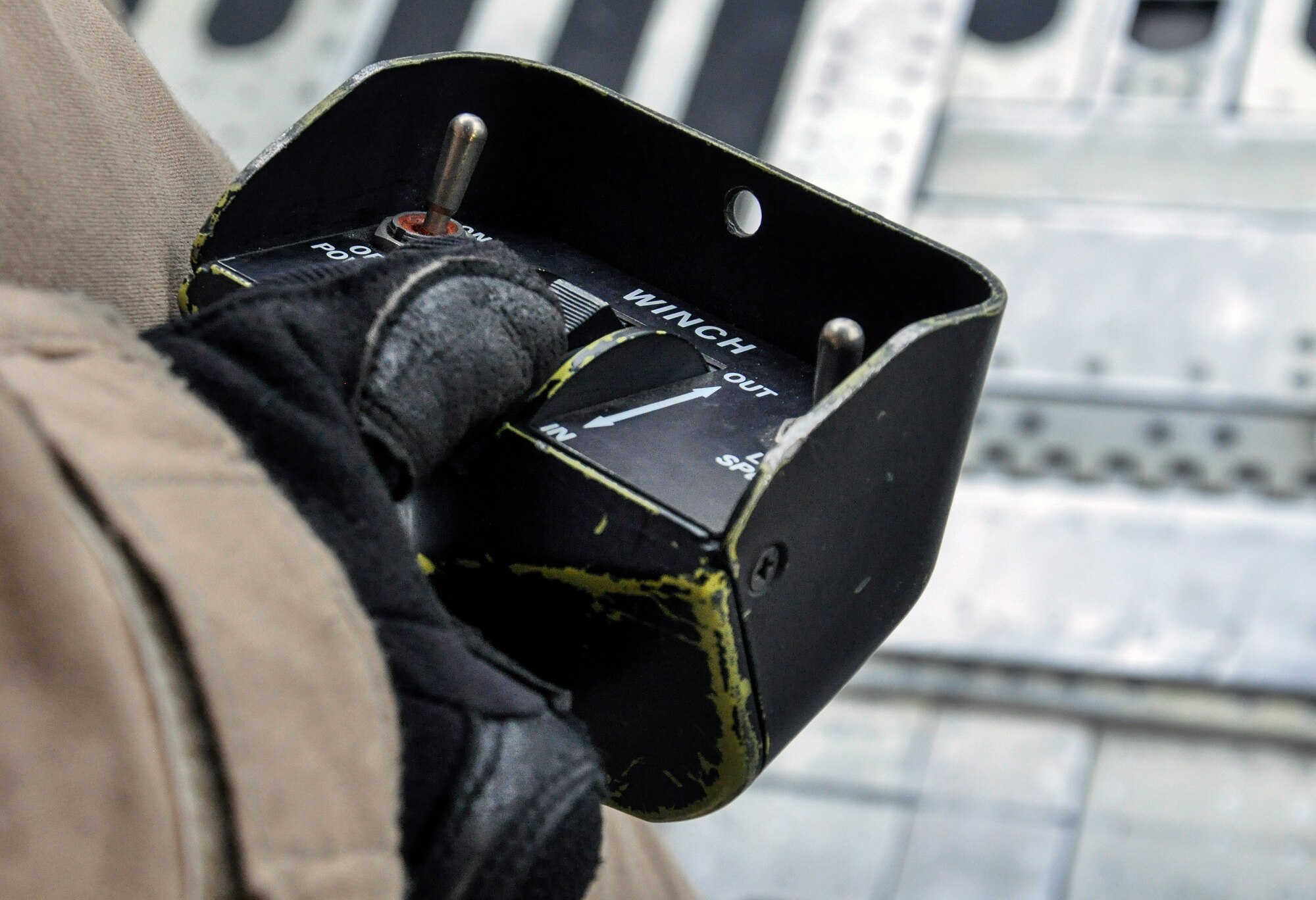 Airman 1st Class Anthony Green, 9th Airlift Squadron, Dover Air Force Base, Del., operates a winch during the unloading of a helicopter from a C-5M Super Galaxy at Bagram Air Field, Afghanistan, Dec. 26, 2015. The C-5M is the largest military transport aircraft in the world, capable of hauling 270,000 pounds of cargo. (U.S. Air Force photo by Tech. Sgt. Nicholas Rau)