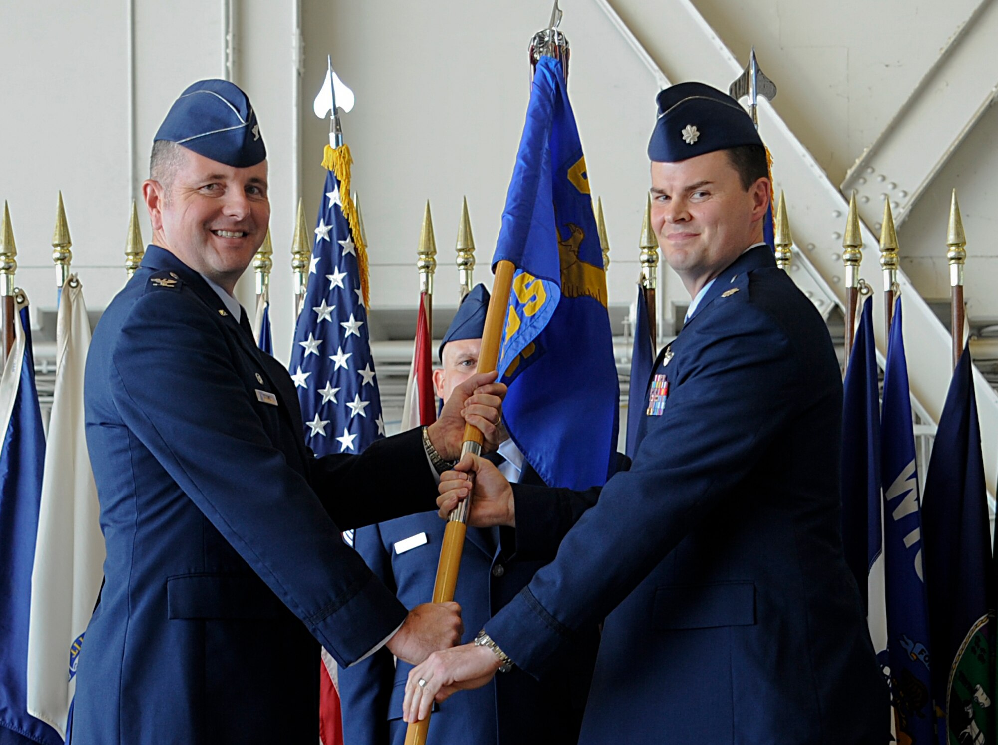 Col. William Stowe, the commander of the 6th Operations Group, passes the 6th Operations Support Squadron guidon to Lt. Col. Chesley Dycus during the 6th OSS change of command ceremony at MacDill Air Force Base, Fla., Jan. 4, 2016. The passing of the guidon symbolizes the beginning of Dycus’ tour as the 6th OSS commander. (U.S. Air Force photo by Airman 1st Class Mariette M. Adams