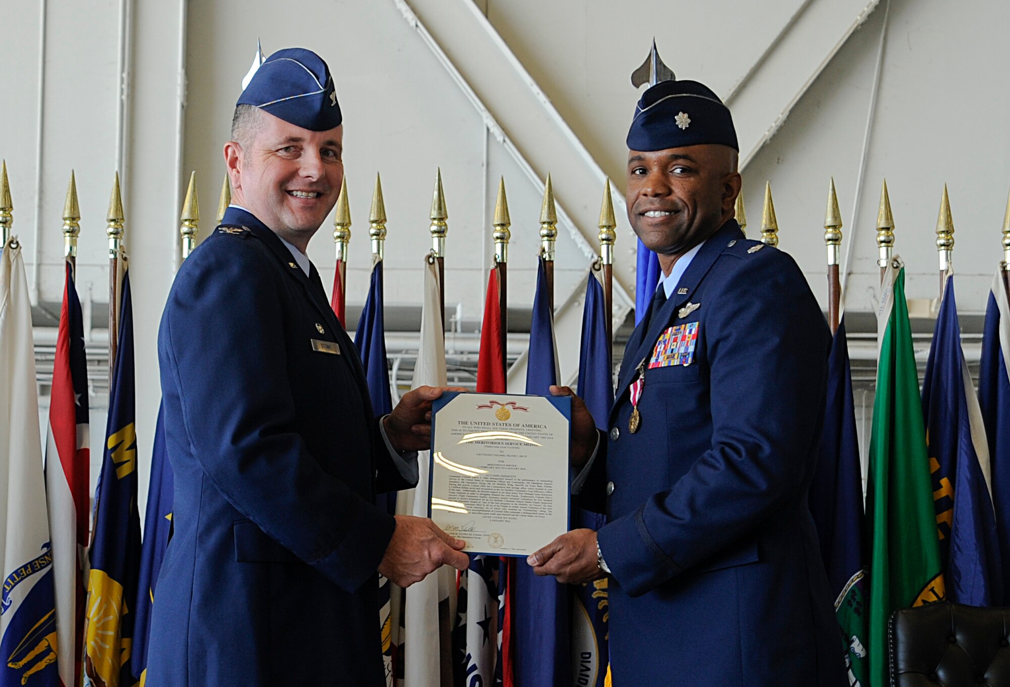 Col. William Stowe, left, the commander of the 6th Operations Group, poses for a photo with, Lt. Col. Travis Diltz, right, former commander of the 6th Operations Support Squadron, after receiving a Meritorious Service Medal during the 6th OSS change of command ceremony at MacDill Air Force Base, Fla., Jan. 4, 2016. During Diltz’s tenure, he led a fuel savings effort of $1.3 million, earning the 6th OSS recognition as the Air Mobility Command 2015 Fuel Efficiency Operations Team of the Year. (U.S. Air Force photo by Airman 1st Class Mariette M. Adams)