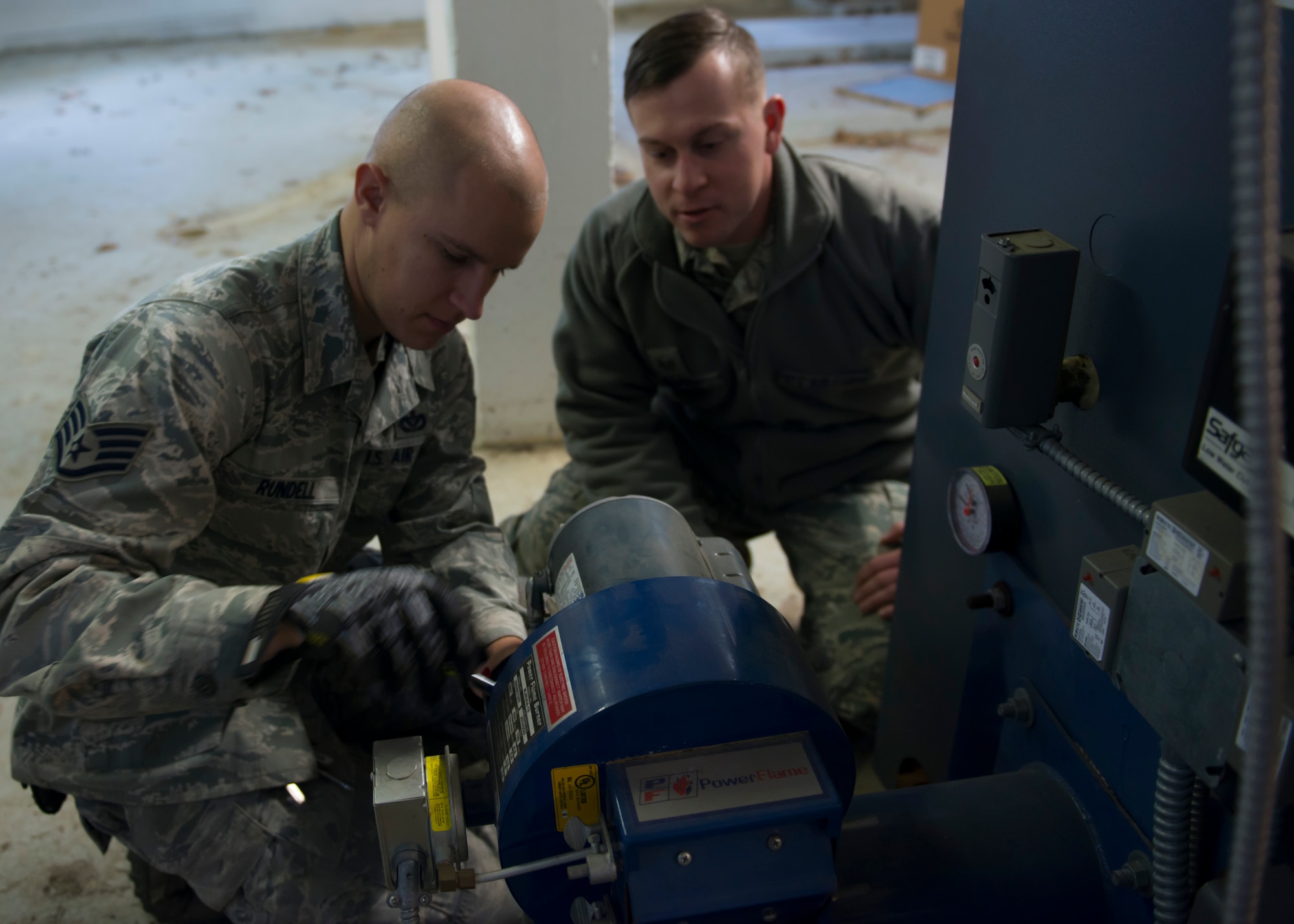 U.S. Air Force Staff Sgts. Will Davey and Chris Rundell, Heating Ventilation and Air Conditioning (HVAC) craftsmen assigned to the 633rd Civil Engineer Squadron, loosen bolts on an HVAC system at Langley Air Force Base, Va., Jan. 5, 2016. HVAC craftsmen install, maintain, repair and operate heating plants, systems and equipment. (U.S. Air Force by Staff Sgt. J.D. Strong II) 