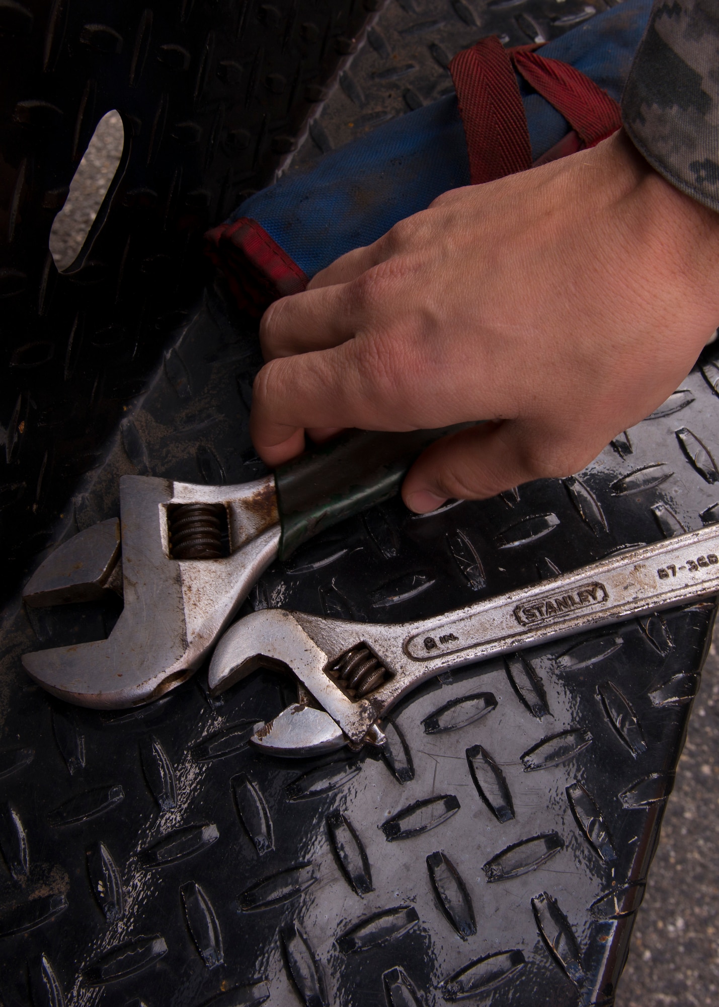 U. S Air Force Staff Sgt. Chris Rundell, Heating Ventilation and Air Conditioning craftsman assigned to the 633rd Civil Engineer Squadron, grabs a crescent wrench at Langley Air Force Base, Va., Jan. 5, 2016. Rundell used the wrench to remove bolts from a boiler during an inspection. (U.S. Air Force by Staff Sgt. J.D. Strong II)