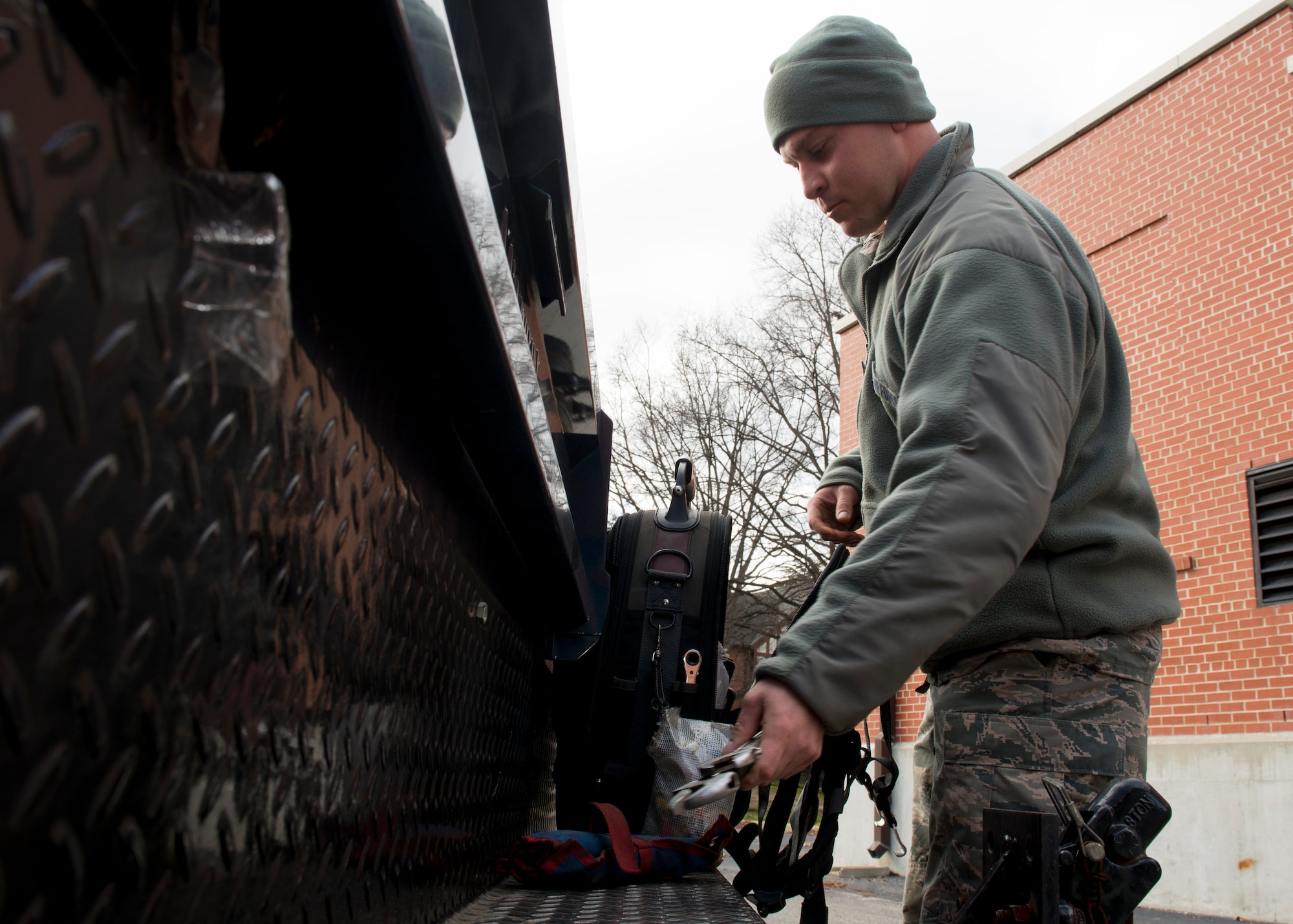 U.S Air Force Staff Sgt. Will Davey, Heating Ventilation and Air Conditioning (HVAC) craftsman assigned to the 633rd Civil Engineer Squadron, removes tools from his bag at Langley Air Force Base, Va., Jan. 5, 2016. Davey works with furnaces, boilers, stoves, heat exchangers, burners, blowers, fans and radiant heaters as an HVAC craftsman. (U.S. Air Force by Staff Sgt. J.D. Strong II)