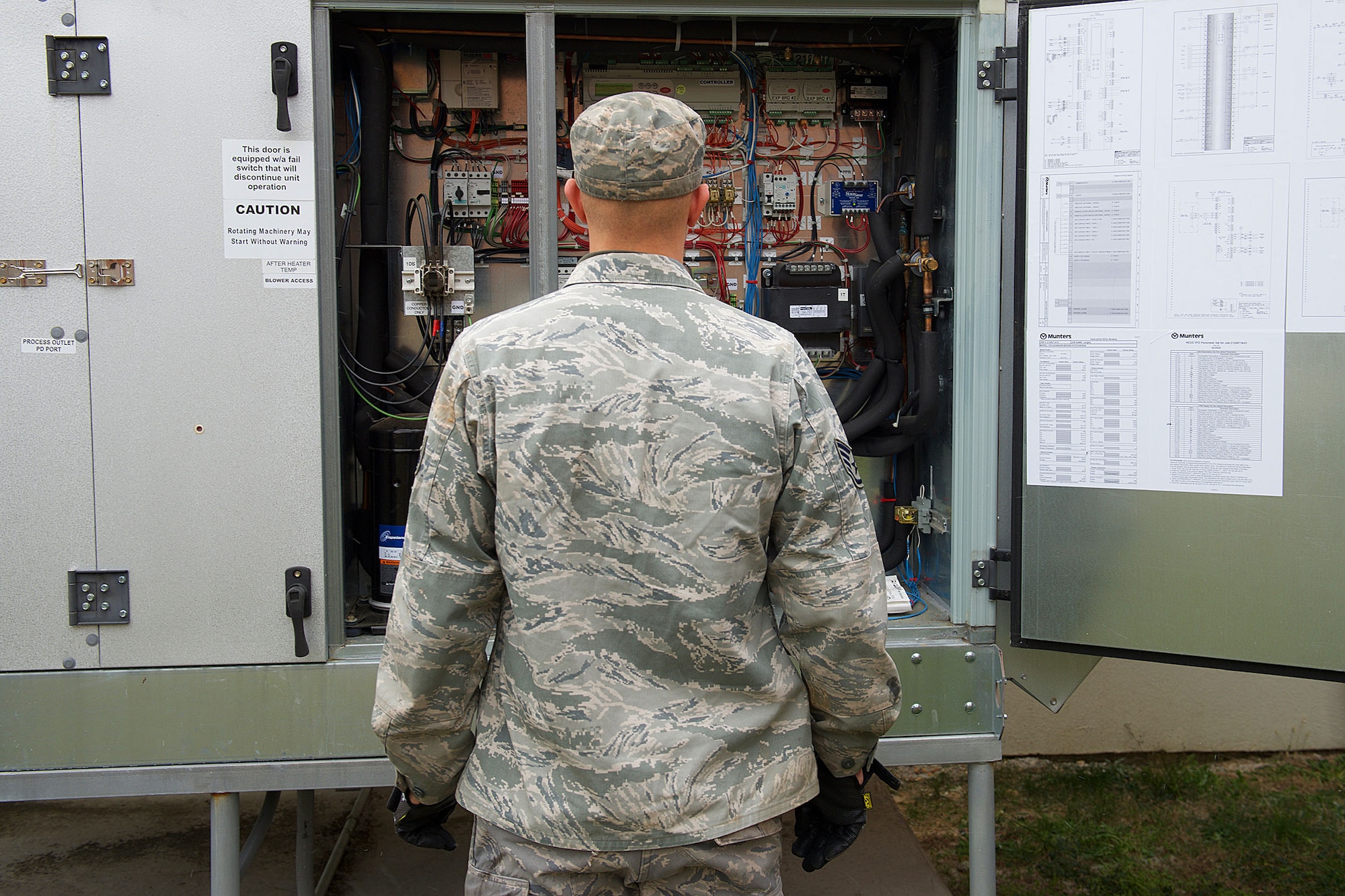 U.S. Air Force Staff Sgt. Chris Rundell, Heating Ventilation and Air Conditioning (HVAC) craftsman assigned to the 633rd Civil Engineer Squadron, analyzes an air flow controller system at Langley Air Force Base, Va., Jan. 5, 2016. As an HVAC craftsman, Rundell maintains electric, electronic and pneumatic controls in refrigeration and cooling equipment. (U.S. Air Force by Staff Sgt. J.D. Strong II)