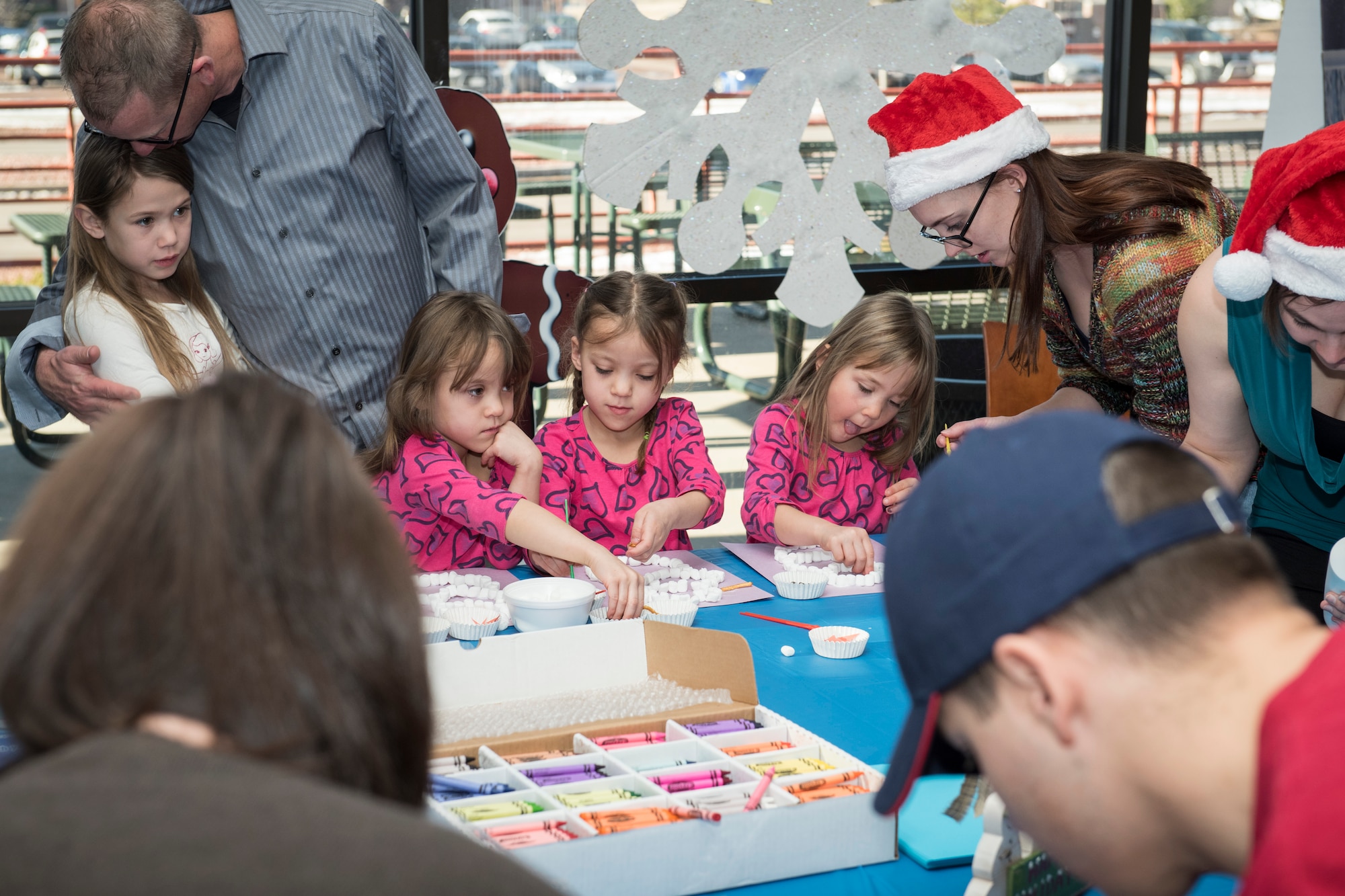 PETERSON AIR FORCE BASE, Colo. – The Gamer triplets, 5, work on marshmallow snowmen at the Winter Wonderland Fest on Dec. 19, 2015 at the Aragon Dining Facility. The “Frozen” themed event consisted of breakfast for Airmen and their families, arts and crafts and photo opportunities with both Santa and characters from “Frozen.” (U.S. Air Force photo by Senior Airman Rose Gudex)