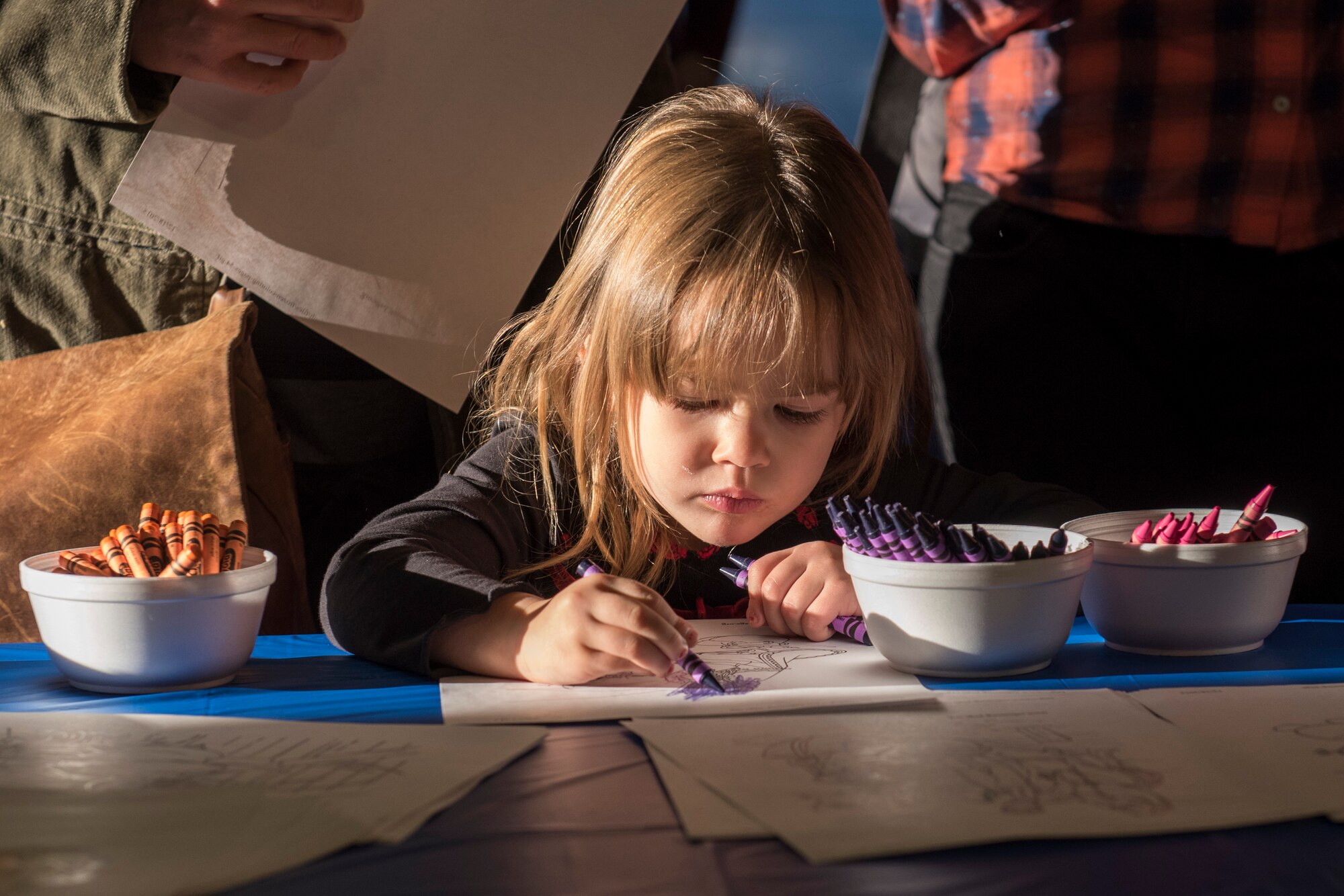 PETERSON AIR FORCE BASE, Colo. – Liliana Kline, 3, colors a “Frozen” coloring page during the Winter Wonderland Fest at the Aragon Dining Facility on Dec. 19, 2015. The event was held for Peterson Airmen and their families to have some winter fun before the holidays, do arts and crafts and take photos with some “Frozen” characters and Santa. (U.S. Air Force photo by Senior Airman Rose Gudex)