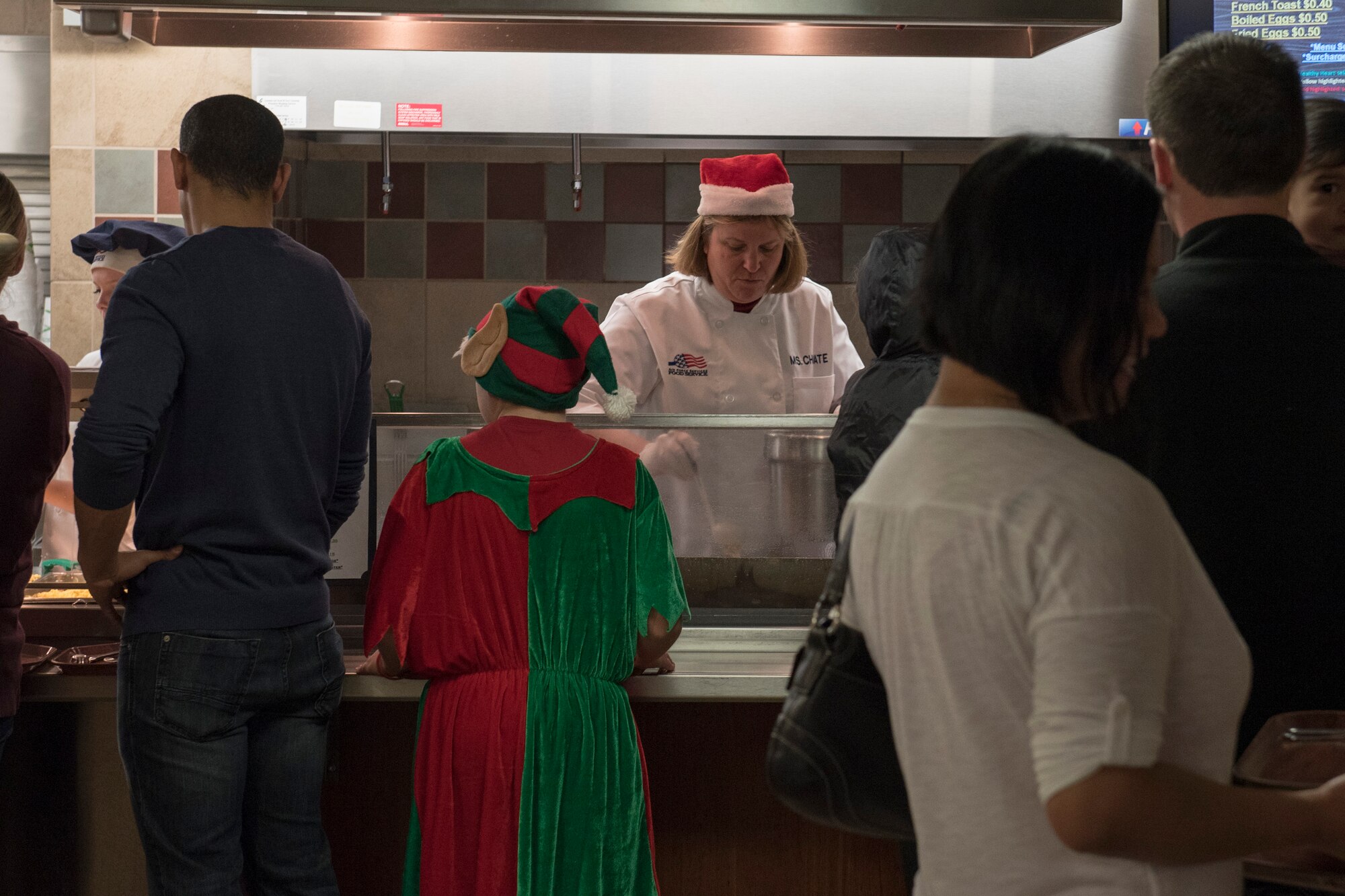 PETERSON AIR FORCE BASE, Colo. – Dorothy Choate, 21st Force Support Squadron deputy director, makes pancakes for attendees of the Winter Wonderland Fest at the Aragon Dining Facility on Dec. 19, 2015. Airmen and their families ate breakfast and participated in arts and crafts all related to the movie “Frozen.” Characters from the movie and Santa also made an appearance. (U.S. Air Force photo by Senior Airman Rose Gudex)