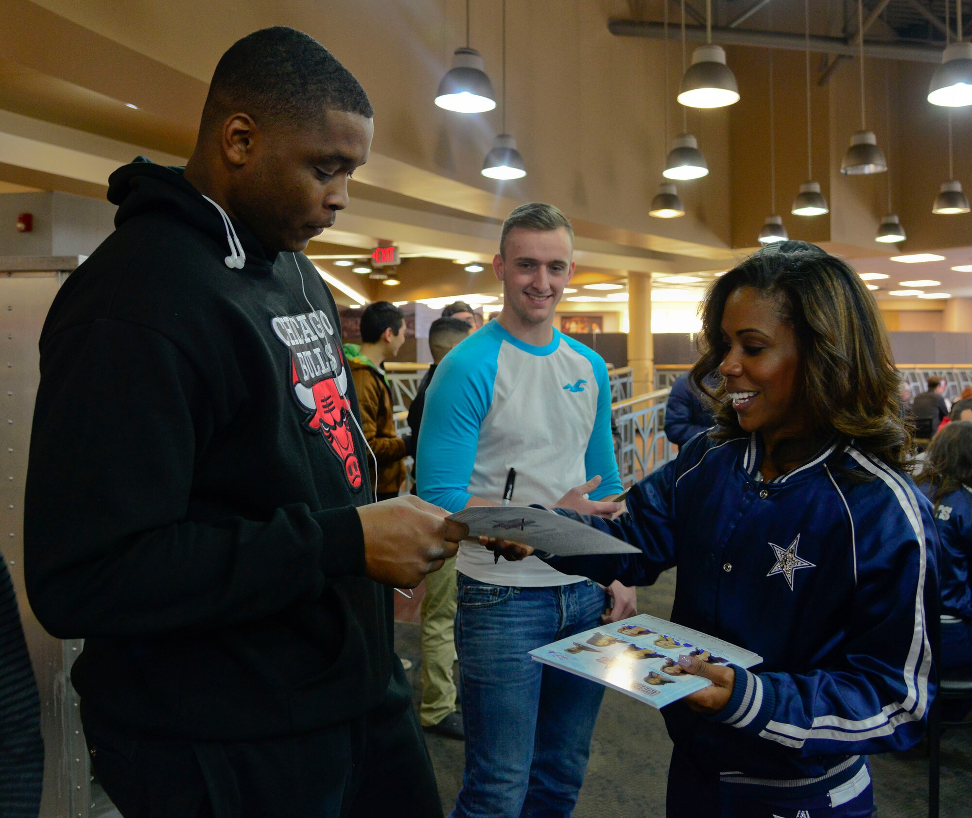 Senior Airman Aaron Faust, 51st Security Forces Squadron, greets Jackie Pearson, Dallas Cowboys Cheerleaders’ youth programs director, during the 74th annual United Service Organizations tour on Osan Air Base, Republic of Korea, Dec. 25, 2015. The USO is a nonprofit organization that provides programs, services and live entertainment to U.S. service members and their families around the world. Throughout the tour the cheerleaders traveled to military installations across the ROK in an effort to boost morale through meet-and-greets and interactive events. (U.S. Air Force photo/Senior Airman Kristin High)