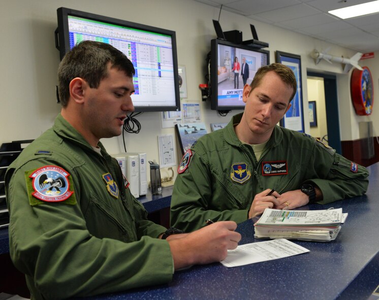 Capt. Chris Umphres (right), 435th Fighter Training Squadron flight commander and instructor pilot, conducts a pre-flight briefing with First Lt. Kaleb Jenkins, 435th FTS student pilot, before a training mission Jan. 5 at Joint Base San Antonio-Randolph, Texas. (U.S. Air Force photo by Tech. Sgt. Beth Anschutz)