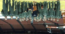 Members of the 435th Fighter Training Squadron pose for a photo with Shaka Smart, head coach of the University of Texas men’s basketball team, 19 Nov. 2015 at the UT basketball stadium. The Deadly Black Eagles met with the coach to discuss leadership and the development of a team. (Courtesy photo) 