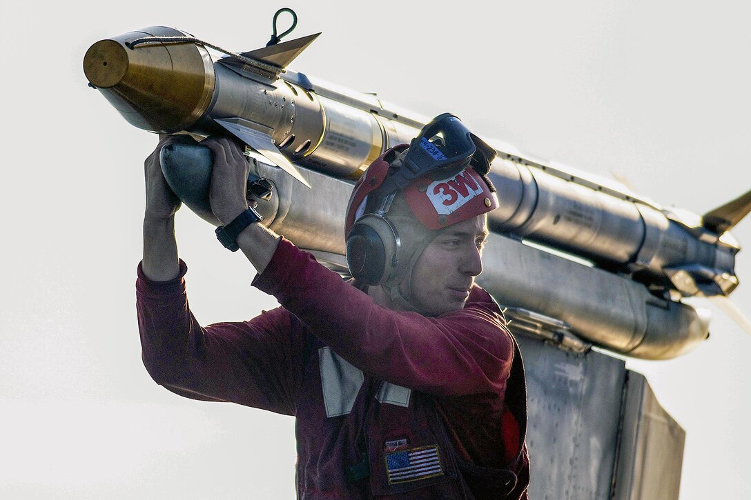 A U.S. sailor performs an ordnance inspection on an F/A-18C Hornet on the flight deck of the aircraft carrier USS Harry S. Truman in the Arabian Gulf, Dec. 29, 2015. The sailor is assigned to Strike Fighter Squadron 83. U.S. Navy photo by Petty Officer 3rd Class J. R. Pacheco