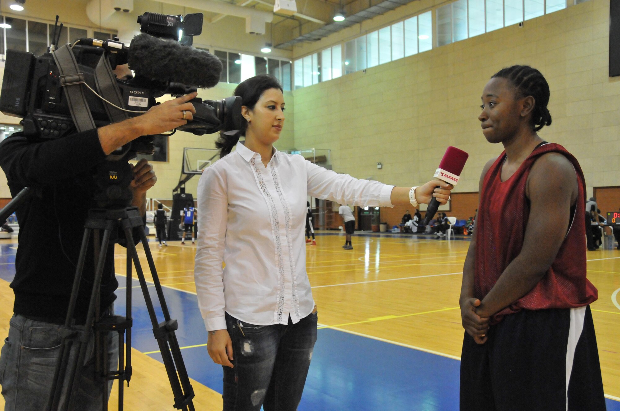 Staff Sgt. Siera Wilson, U.S. Central Command joint security office administration non-commissioned officer in charge, was interviewed by Nadia Zerbane, Al Kass Sports Channel producer at the three on three basketball tournament Jan. 2 at Al Gharafa Multi-Purpose Hall, Doha. Wilson was one of the team captains for the Al Udeid Air Base, Qatar women’s team. (U.S. Air Force photo by Tech. Sgt. Terrica Y. Jones/released)