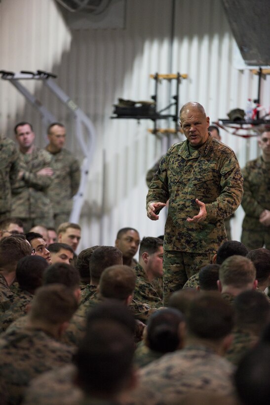 General Robert B. Neller, Commandant of the Marine Corps, speaks with Marines and Sailors with the Black Sea Rotational Force during his visit at Mihail Kogalniceanu Air Base, Romania, Dec. 25, 2015. General Neller and Sgt. Maj. Ronald L. Green, Sergeant Major of the Marine Corps, visited the base and engaged the Marines and offer them the opportunity to ask questions. (U.S. Marine Corps photo by Lance Cpl. Melanye E. Martinez/Released)