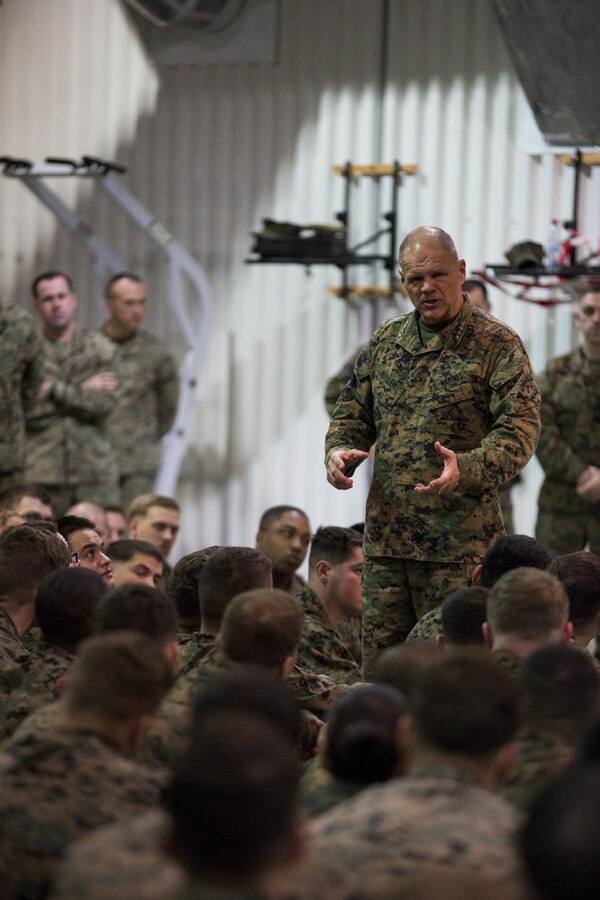 General Robert B. Neller, Commandant of the Marine Corps, speaks with Marines and Sailors with the Black Sea Rotational Force during his visit at Mihail Kogalniceanu Air Base, Romania, Dec. 25, 2015. General Neller and Sgt. Maj. Ronald L. Green, Sergeant Major of the Marine Corps, visited the base and engaged the Marines and offer them the opportunity to ask questions. (U.S. Marine Corps photo by Lance Cpl. Melanye E. Martinez/Released)