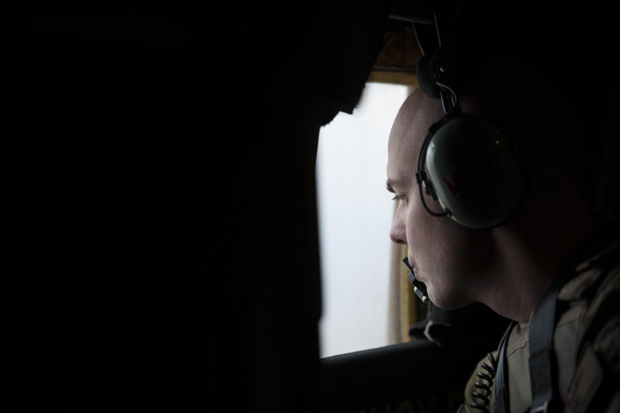 Staff Sgt. Justin King, 774th Expeditionary Airlift Squadron loadmaster, deployed from Dyess Air Force Base, Texas, scans for threats through the window of a C-130J Super Hercules in route to Camp Bastion, Afghanistan, from Bagram Airfield, Jan. 3, 2016. Loadmasters are responsible for calculating aircraft weight, balancing records and cargo manifests, conducting cargo and personnel airdrops, and troubleshooting in-flight problems. (U.S. Air Force photo/Tech. Sgt. Robert Cloys)