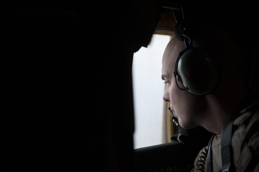 Staff Sgt. Justin King, 774th Expeditionary Airlift Squadron loadmaster, deployed from Dyess Air Force Base, Texas, scans for threats through the window of a C-130J Super Hercules in route to Camp Bastion, Afghanistan, from Bagram Airfield, Jan. 3, 2016. Loadmasters are responsible for calculating aircraft weight, balancing records and cargo manifests, conducting cargo and personnel airdrops, and troubleshooting in-flight problems. (U.S. Air Force photo/Tech. Sgt. Robert Cloys)