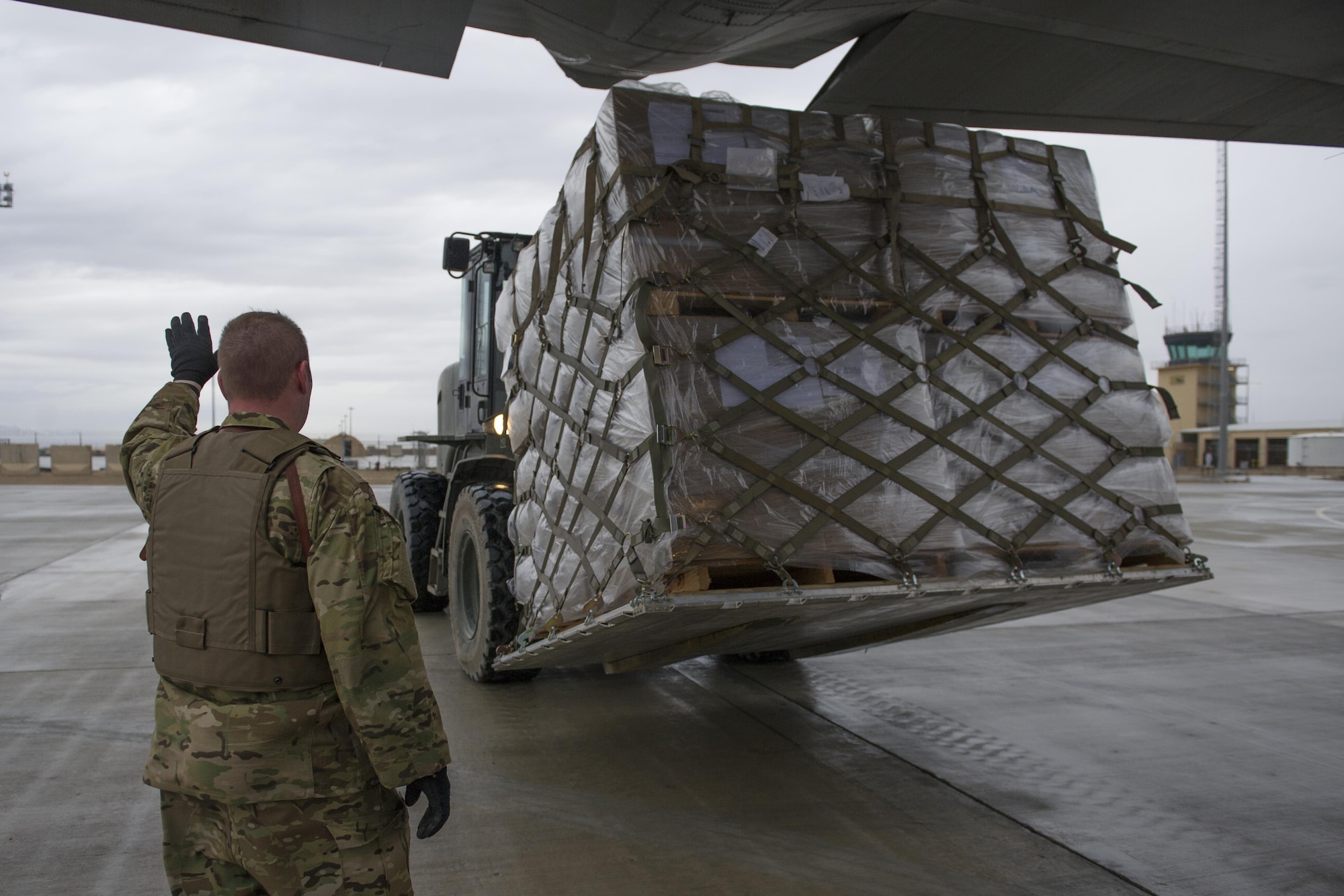 Staff Sgt. Michael Demik, 774th Expeditionary Airlift Squadron loadmaster, deployed from Dyess Air Force Base, Texas, guides a forklift toward the aft loading ramp of a C-130J Super Hercules at Camp Bastion, Afghanistan, Jan. 3, 2016. Loadmasters are responsible for calculating aircraft weight, balancing records and cargo manifests, conducting cargo and personnel airdrops, and troubleshooting in-flight problems. (U.S. Air Force photo/Tech. Sgt. Robert Cloys)