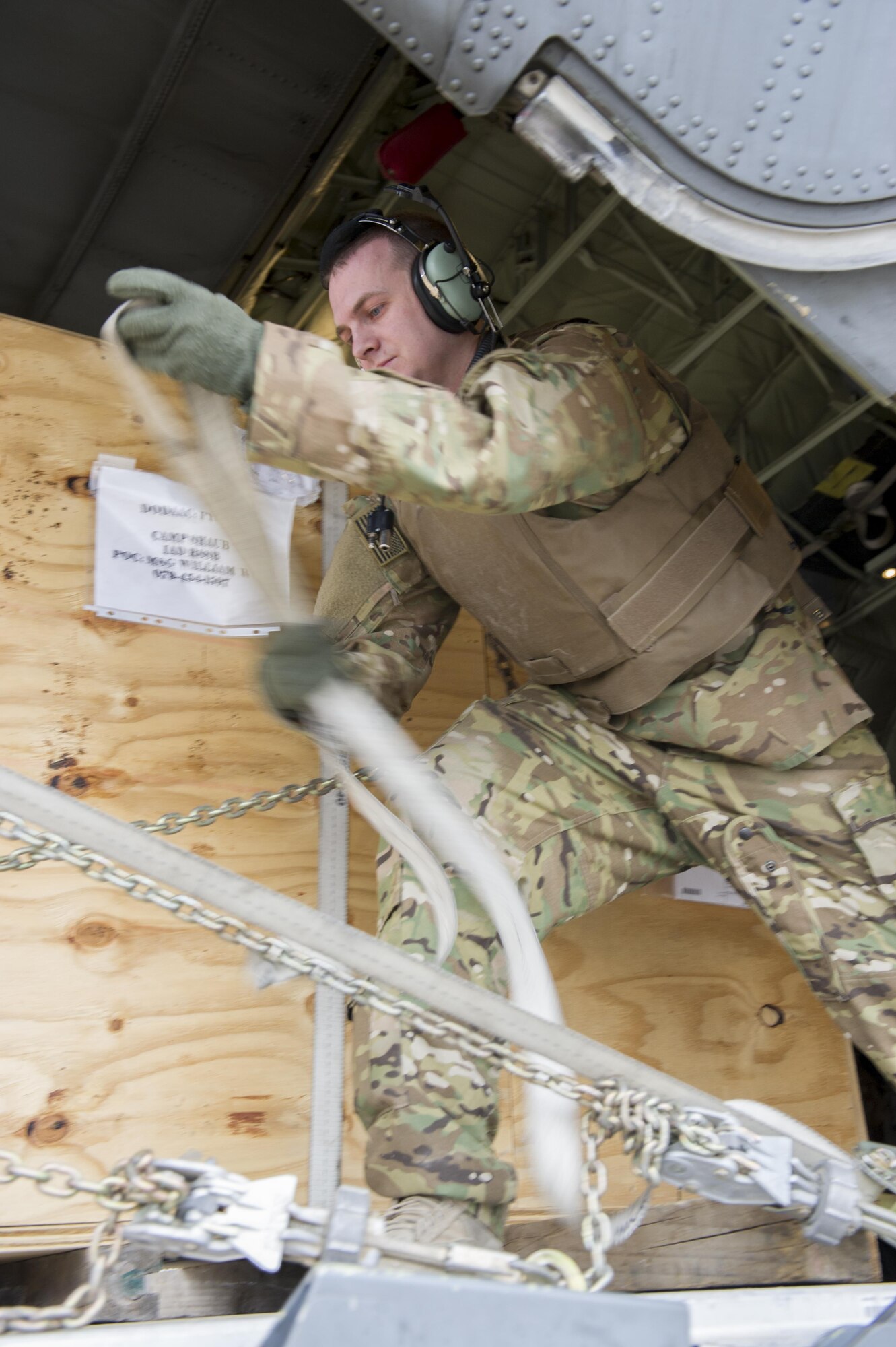 Staff Sgt. Scott McGuire, 774th Expeditionary Airlift Squadron loadmaster, deployed from Dyess Air Force Base, Texas, adjusts the straps on cargo being loaded on to a forklift at Camp Bastion, Afghanistan, Jan. 3, 2016. Loadmasters are responsible for calculating aircraft weight, balancing records and cargo manifests, conducting cargo and personnel airdrops, and troubleshooting in-flight problems. (U.S. Air Force photo/Tech. Sgt. Robert Cloys)