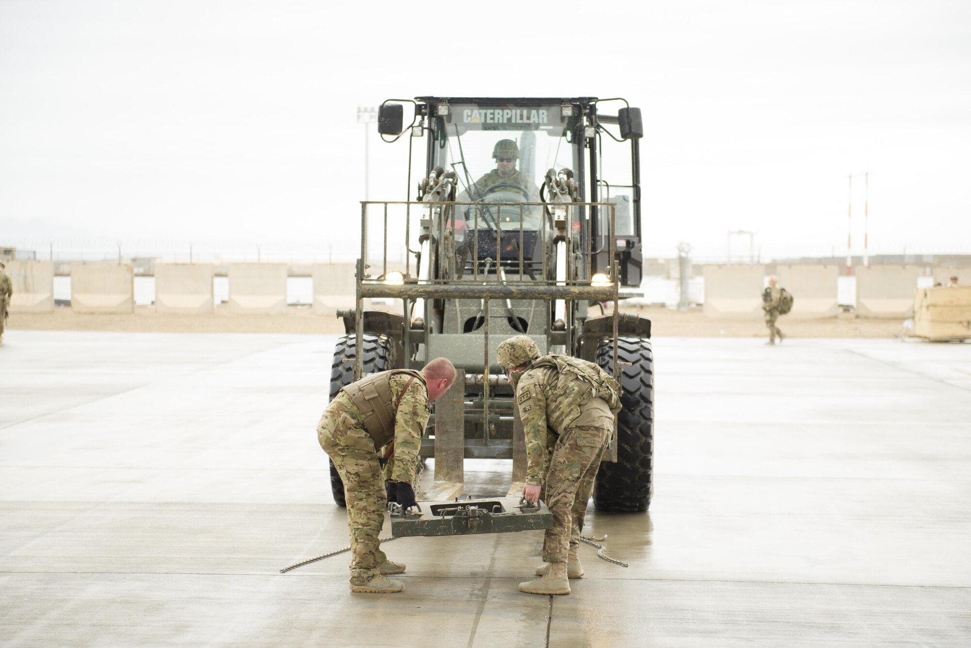 Staff Sgt. Michael Demik, 774th Expeditionary Airlift Squadron loadmaster (left), deployed from Dyess Air Force Base, Texas, prepares a forklift to move a trailer along with the help of a CENTCOM Materiel Recovery Element member at Camp Bastion, Afghanistan, Jan. 3, 2016. Loadmasters are responsible for calculating aircraft weight, balancing records and cargo manifests, conducting cargo and personnel airdrops, and troubleshooting in-flight problems. (U.S. Air Force photo/Tech. Sgt. Robert Cloys)