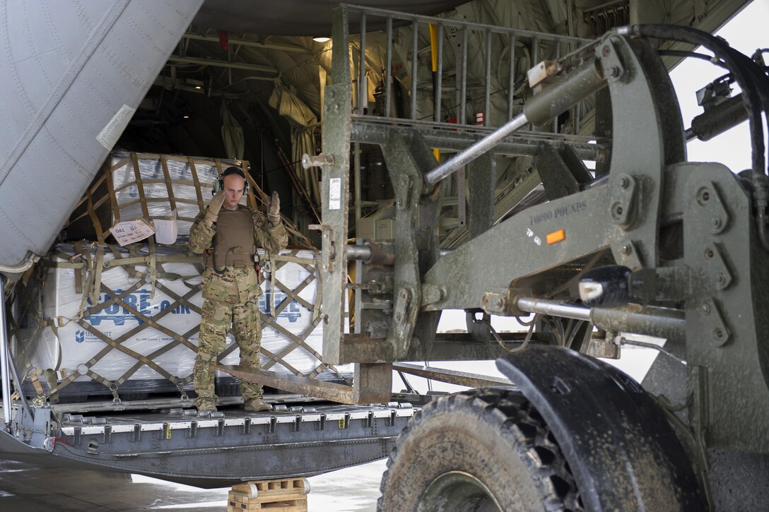 U.S. Air Force Staff Sgt. Justin King guides a forklift toward the aft loading ramp of a C-130J Super Hercules aircraft at Camp Bastion, Afghanistan, Jan. 3, 2016. King is a loadmaster assigned to the 774th Expeditionary Airlift Squadron, deployed from Dyess Air Force Base, Texas. U.S. Air Force photo by Tech. Sgt. Robert Cloys