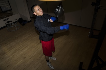 Senior Airman Dustin Southichack, 902nd Security Forces Squadron entry controller, performs speed bag drills Jan. 5, 2015 at the Joint Base San Antonio-Randolph Rambler Fitness Center. Southichack has competed on the Air Force Boxing Team since 2012, and his goals include retiring from the Air Force Reserves and becoming a boxing world champion. (U.S. Air Force photo by Senior Airman Alexandria Slade)