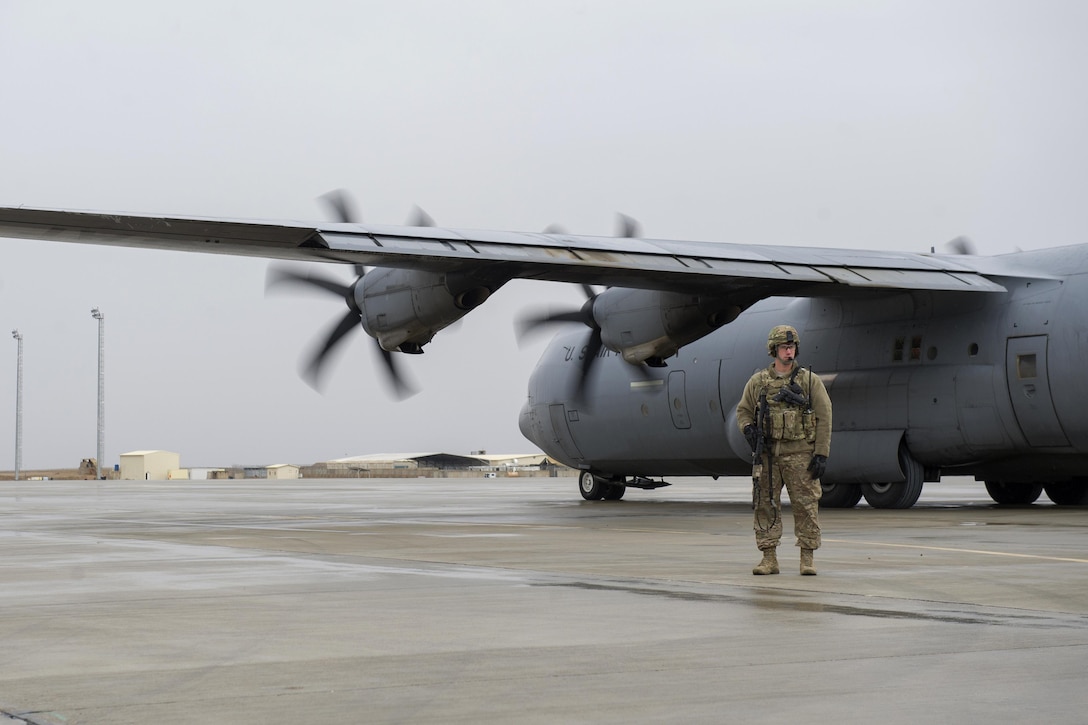 U.S. Air Force Staff Sgt. Tyler Berogan provides security as a C-130J Super Hercules aircraft is unloaded at Camp Bastion, Afghanistan, Jan. 3, 2016. Berogan is assigned to the 455th Expeditionary Security Forces Squadron Fly Away Security Team. U.S. Air Force photo by Tech. Sgt. Robert Cloys