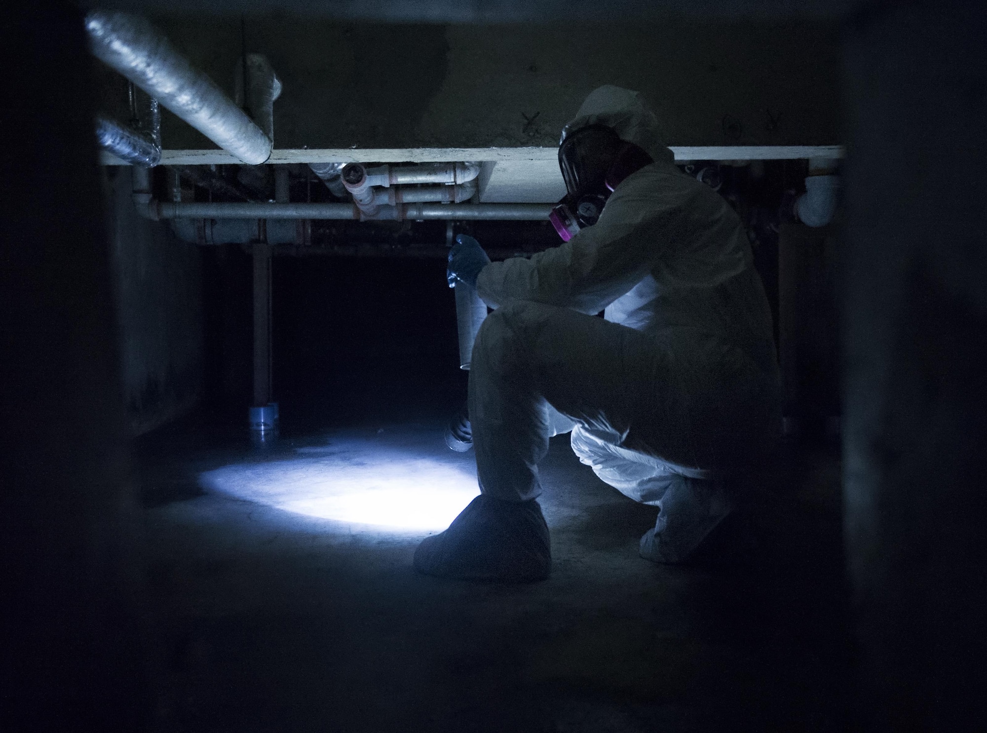 Staff Sgt. Brandon Cenarrusa, a 374th Civil Engineer Squadron pest management craftsman, inspects the crawlspace at Yokota Air Base, Japan, Jan. 6, 2016. To ensure that facilities on Yokota AB remain pest free, entomology Airmen identify and repair any infrastructure imperfections that may lead to pest. (U.S. Air Force photo/Airman 1st Class Delano Scott)