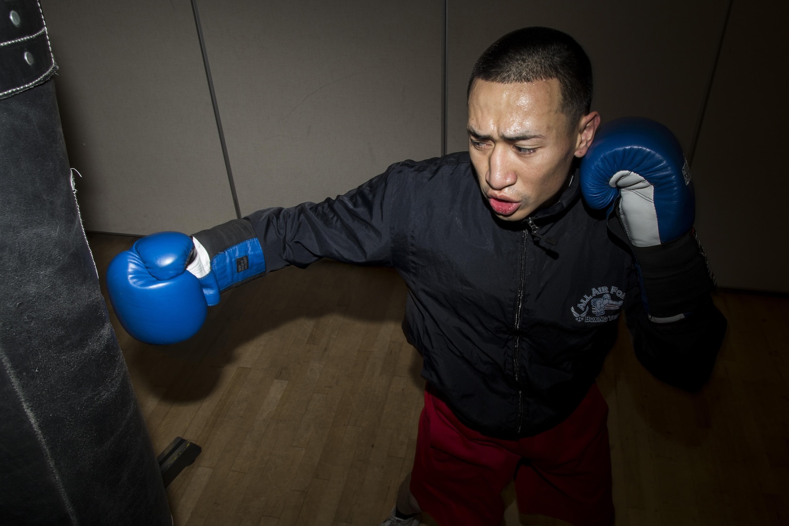 Senior Airman Dustin Southichack, 902nd Security Forces Squadron entry controller, performs heavy bag drills Jan. 5, 2015 at the Joint Base San Antonio-Randolph Rambler Fitness Center. Southichack has competed on the Air Force Boxing Team since 2012, and his goals include retiring from the Air Force Reserves and becoming a boxing world champion. (U.S. Air Force photo by Senior Airman Alexandria Slade)
