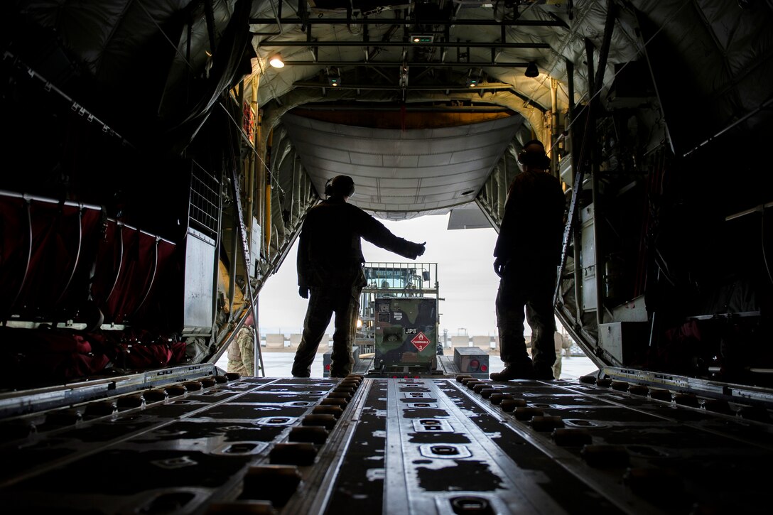 U.S. Air Force Staff Sgt. Scott McGuire, left, gives a thumbs up after a generator is offloaded from a C-130J Super Hercules aircraft at Camp Bastion, Afghanistan, Jan. 3, 2016. McGuire is a loadmaster assigned to the 774th Expeditionary Airlift Squadron, deployed from Dyess Air Force Base, Texas. U.S. Air Force photo by Tech. Sgt. Robert Cloys